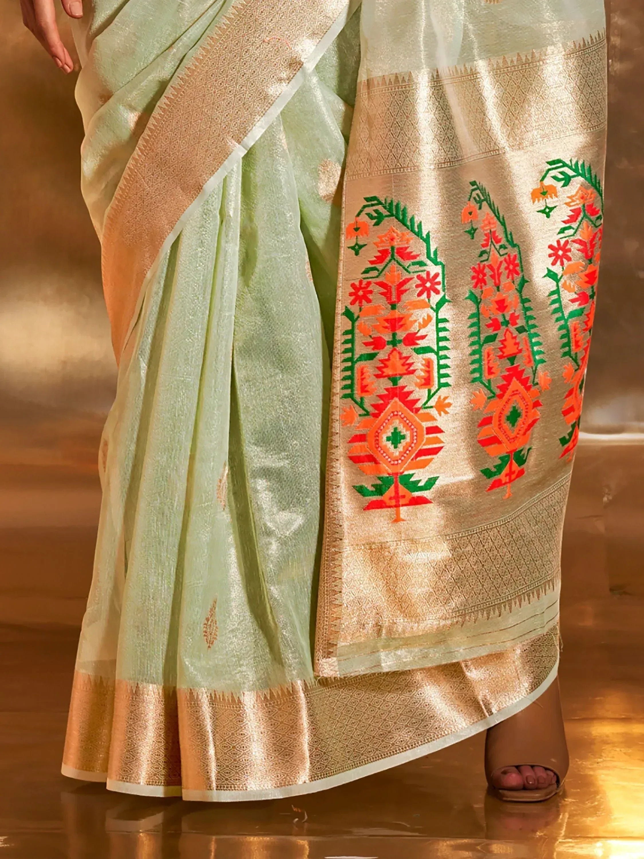 Light green saree with gold border and vibrant floral embroidery, perfect for ethnic occasions.