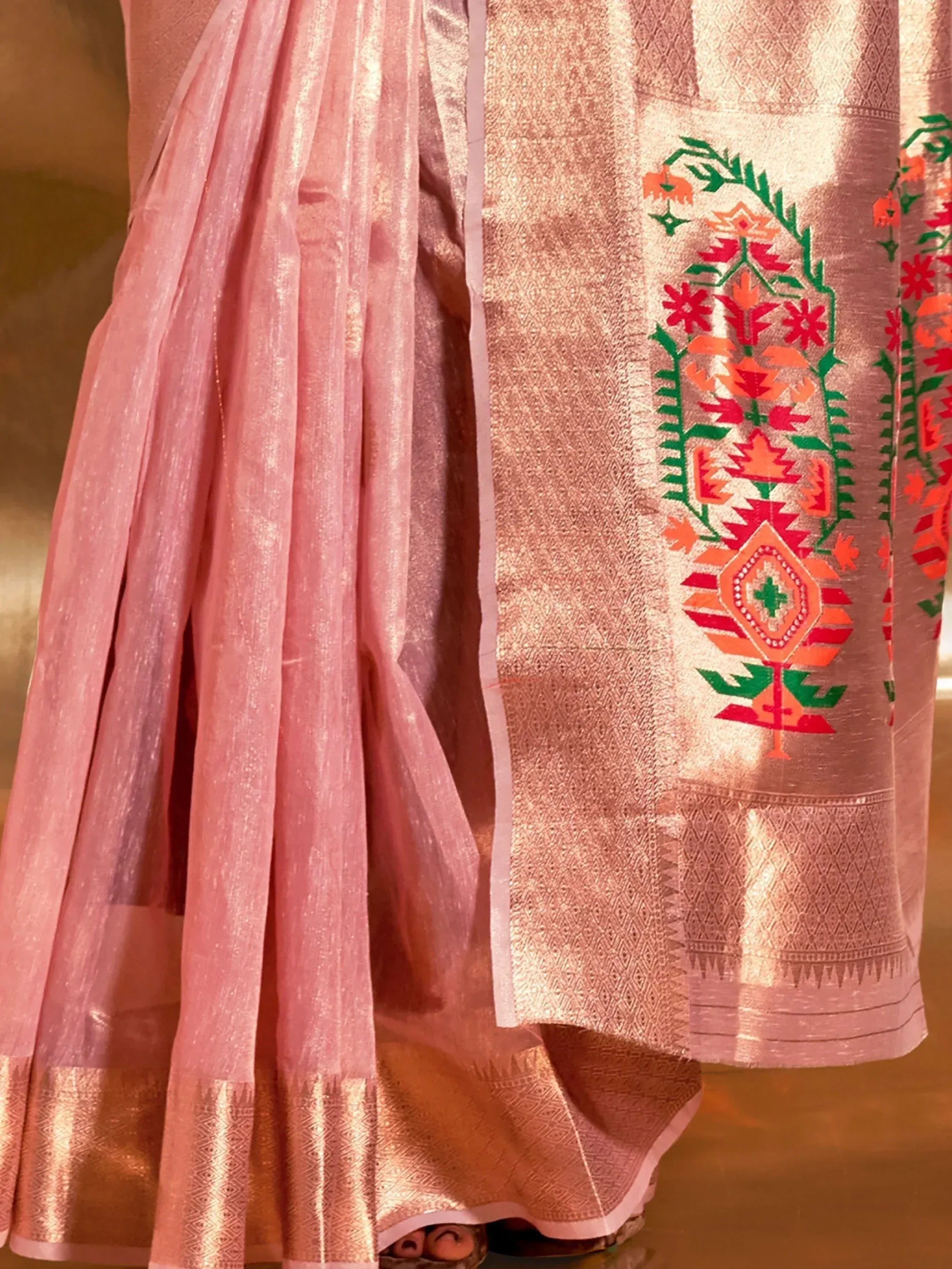 Pink ethnic saree with floral embroidery and golden border, perfect for Indian occasions