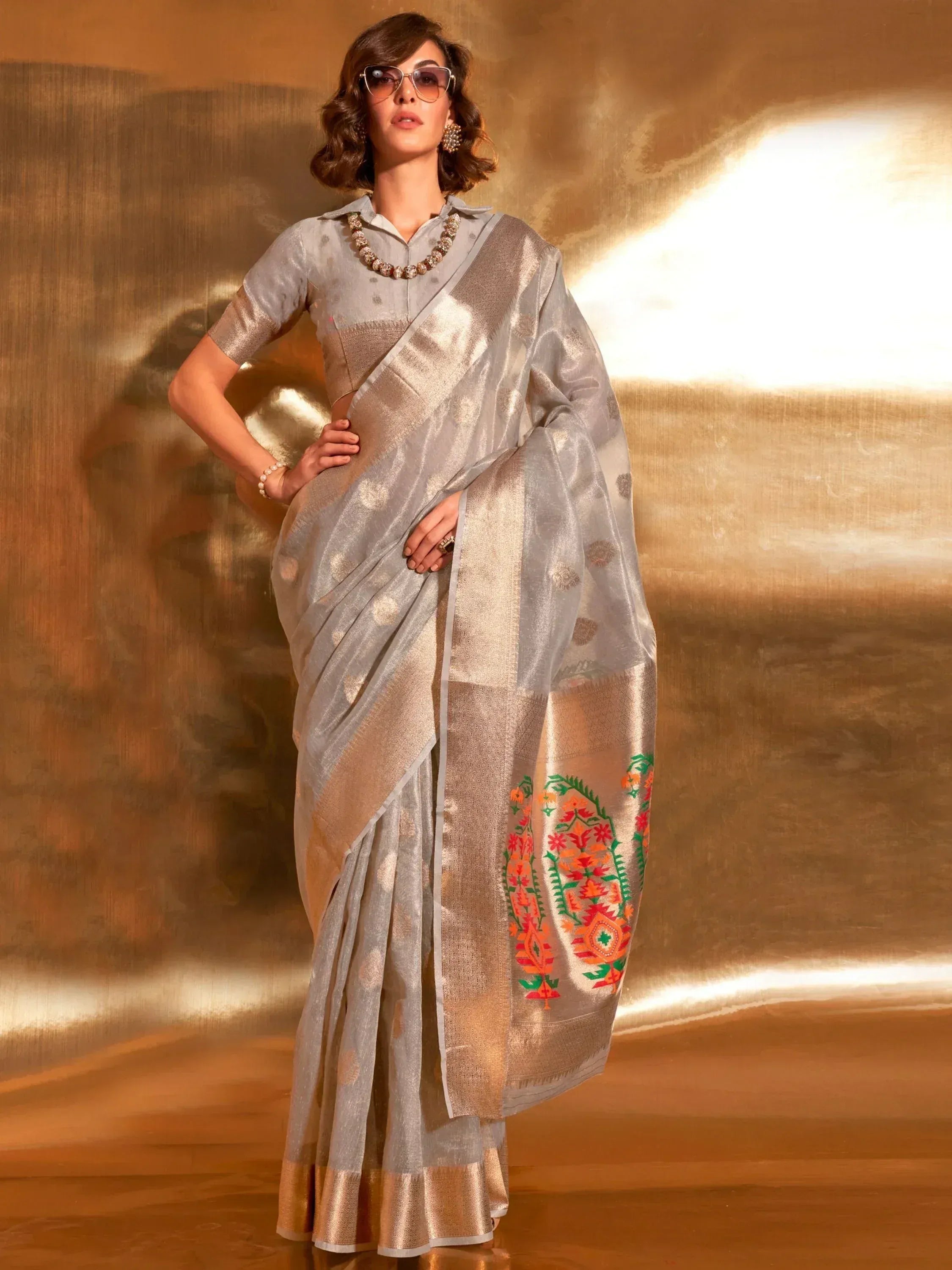 Elegant silver saree with gold border and colorful floral embroidery, styled with blouse for Indian ethnic wear