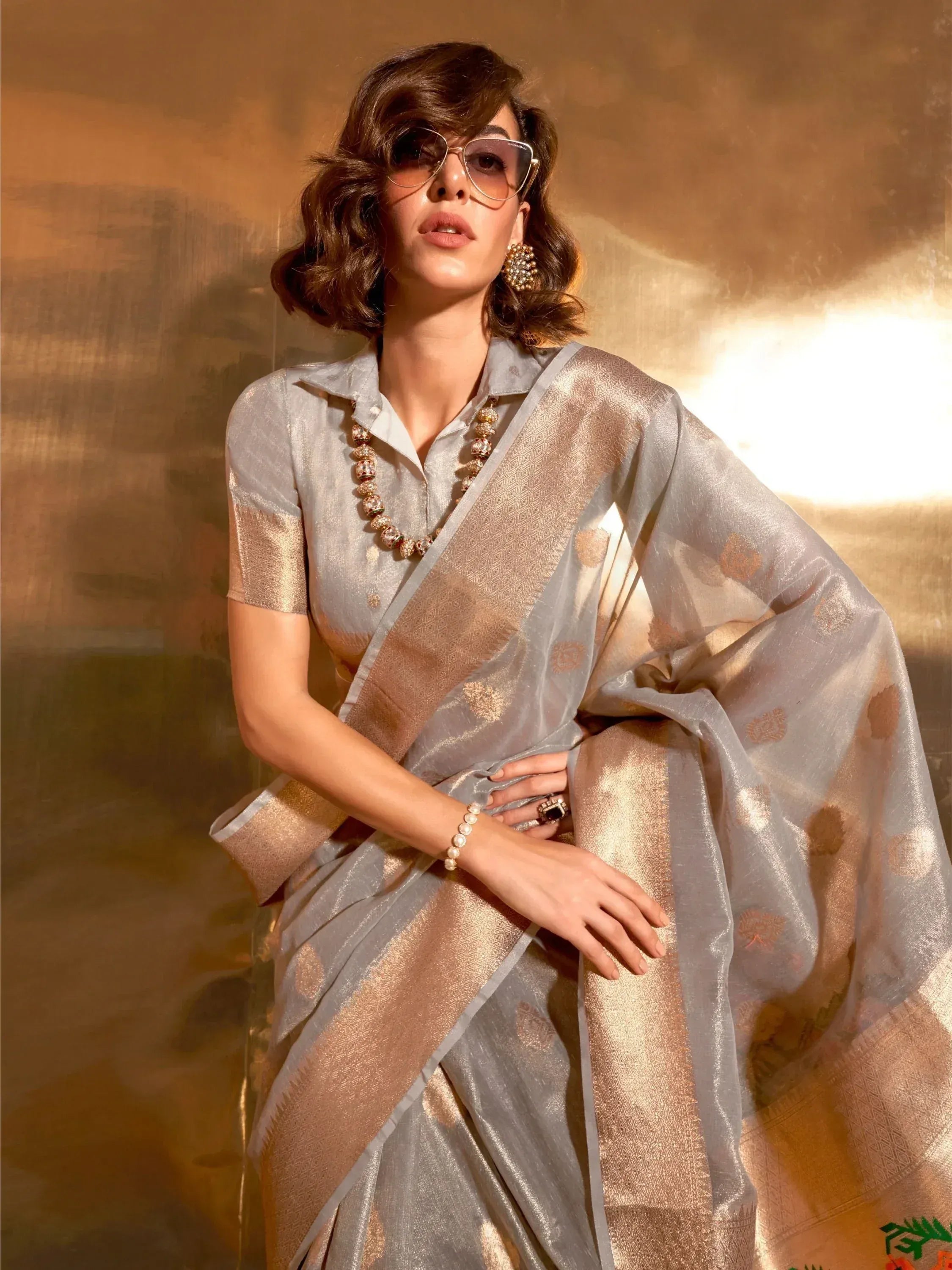 Elegant woman in silver and gold designer saree with blouse, perfect for Indian ethnic wear occasions
