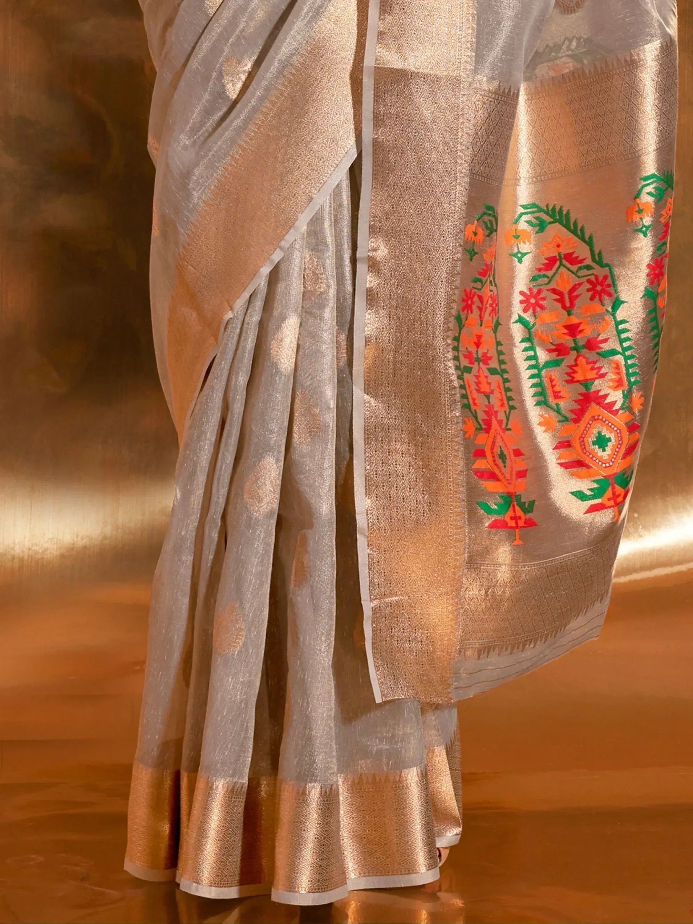 White and gold saree with vibrant floral embroidery, perfect for Indian ethnic wear occasions.
