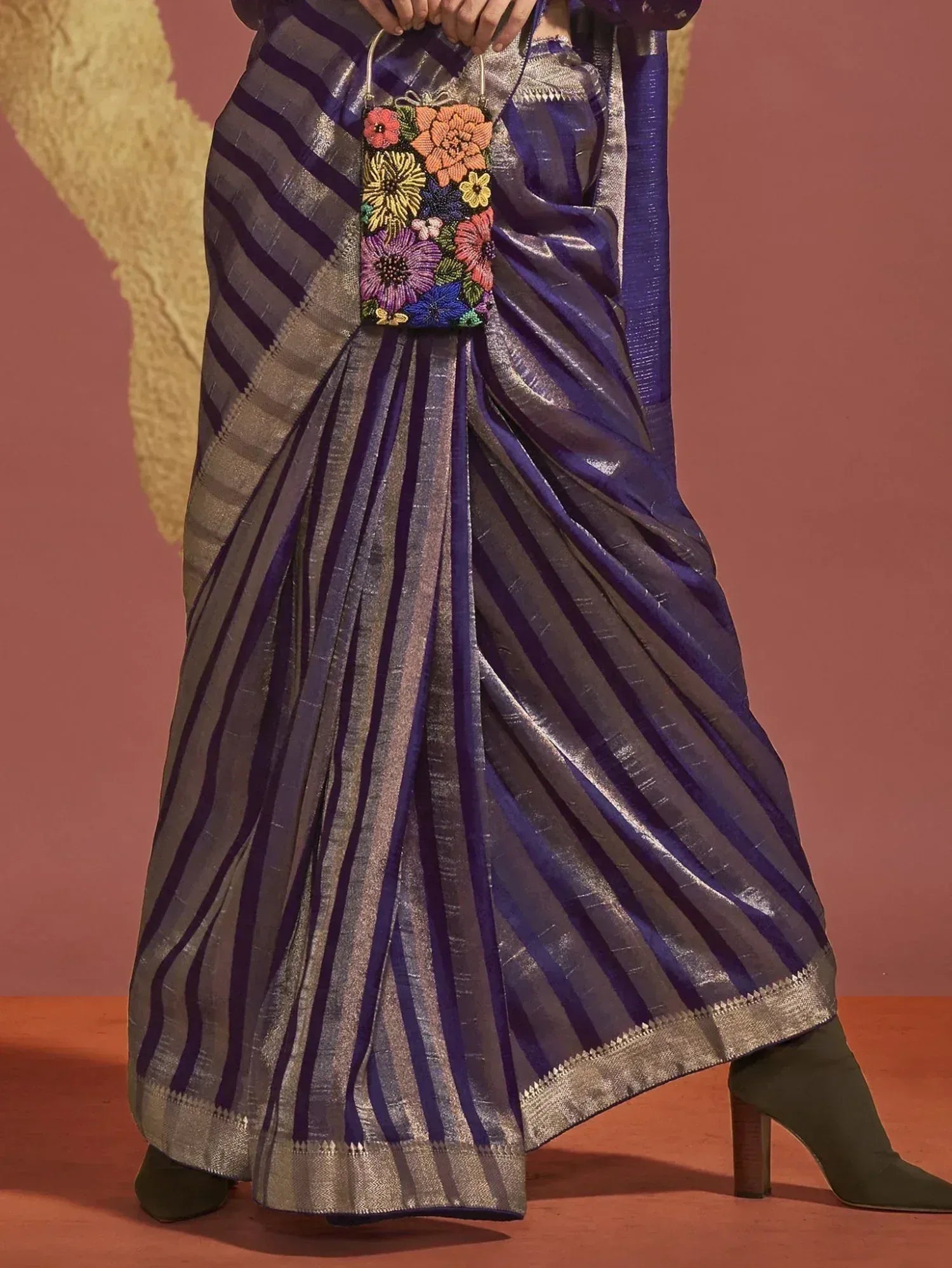 Purple and silver striped saree with floral beaded clutch, styled with green heels for ethnic wear