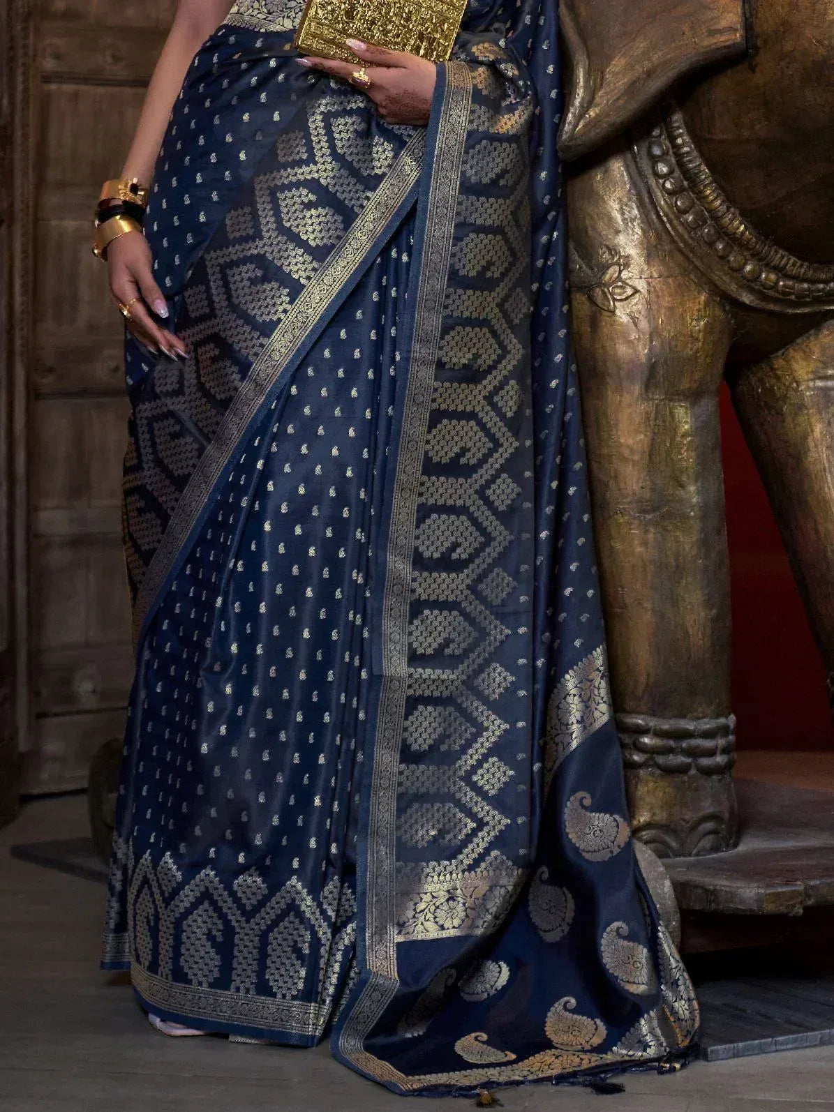 Navy blue designer saree with gold geometric and paisley motifs, perfect for Indian ethnic wear occasions.
