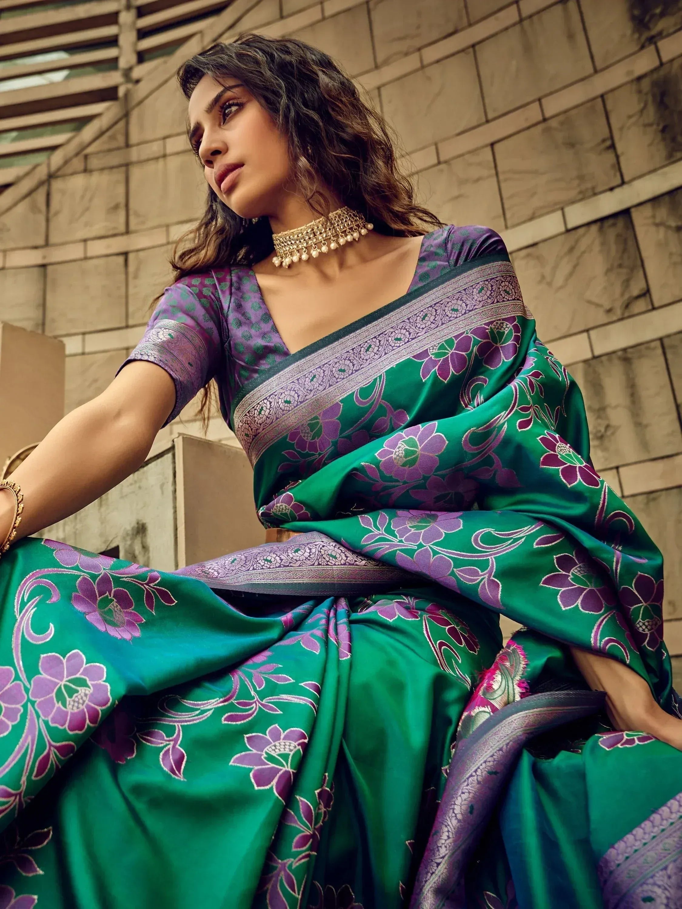 Woman in green and purple floral saree with gold jewelry, ethnic Indian wear