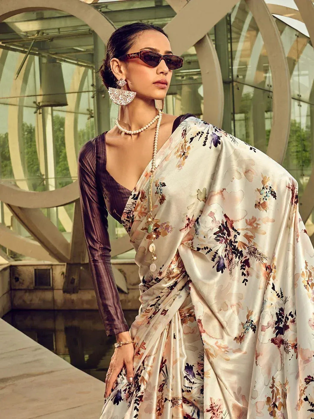 Floral print saree with purple blouse, pearl jewelry, and sunglasses for ethnic wear
