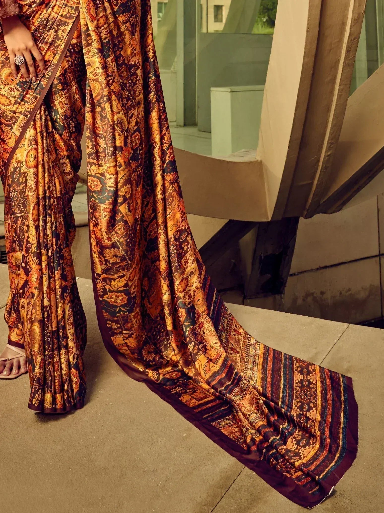 Elegant Indian saree with rich orange and maroon floral print, perfect for ethnic occasions.