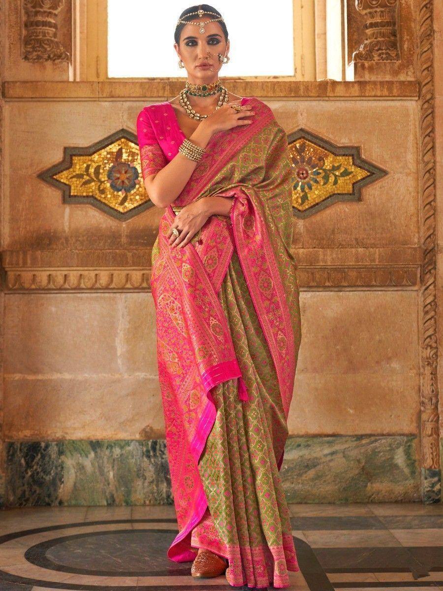 Pink and green designer saree with gold embroidery, styled with traditional jewelry for ethnic occasions