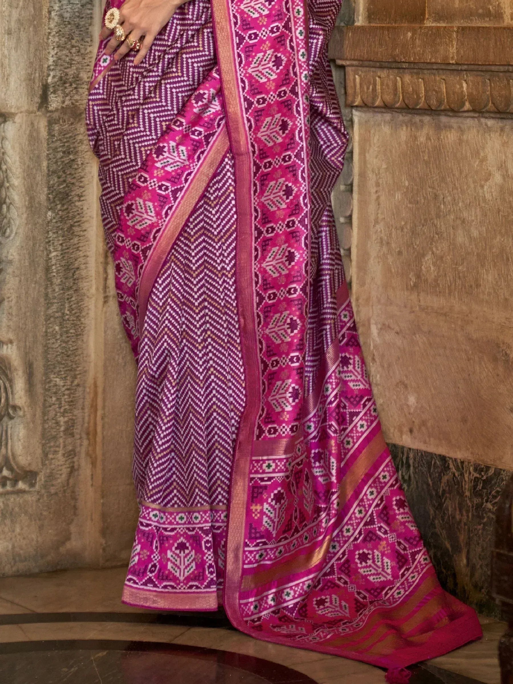 Vibrant pink and purple ethnic saree with geometric patterns, perfect for Indian festive occasions.