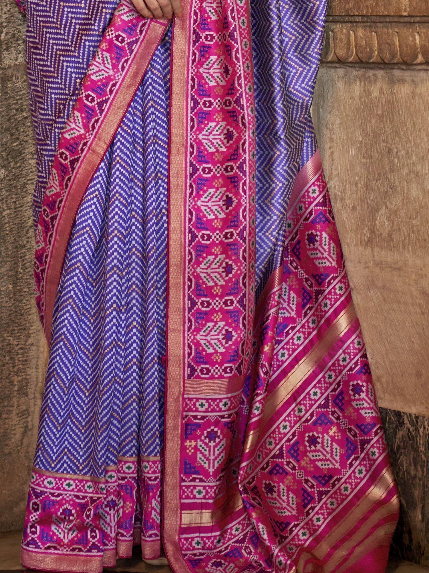Purple and pink ethnic saree with intricate geometric patterns and gold border, ideal for traditional occasions