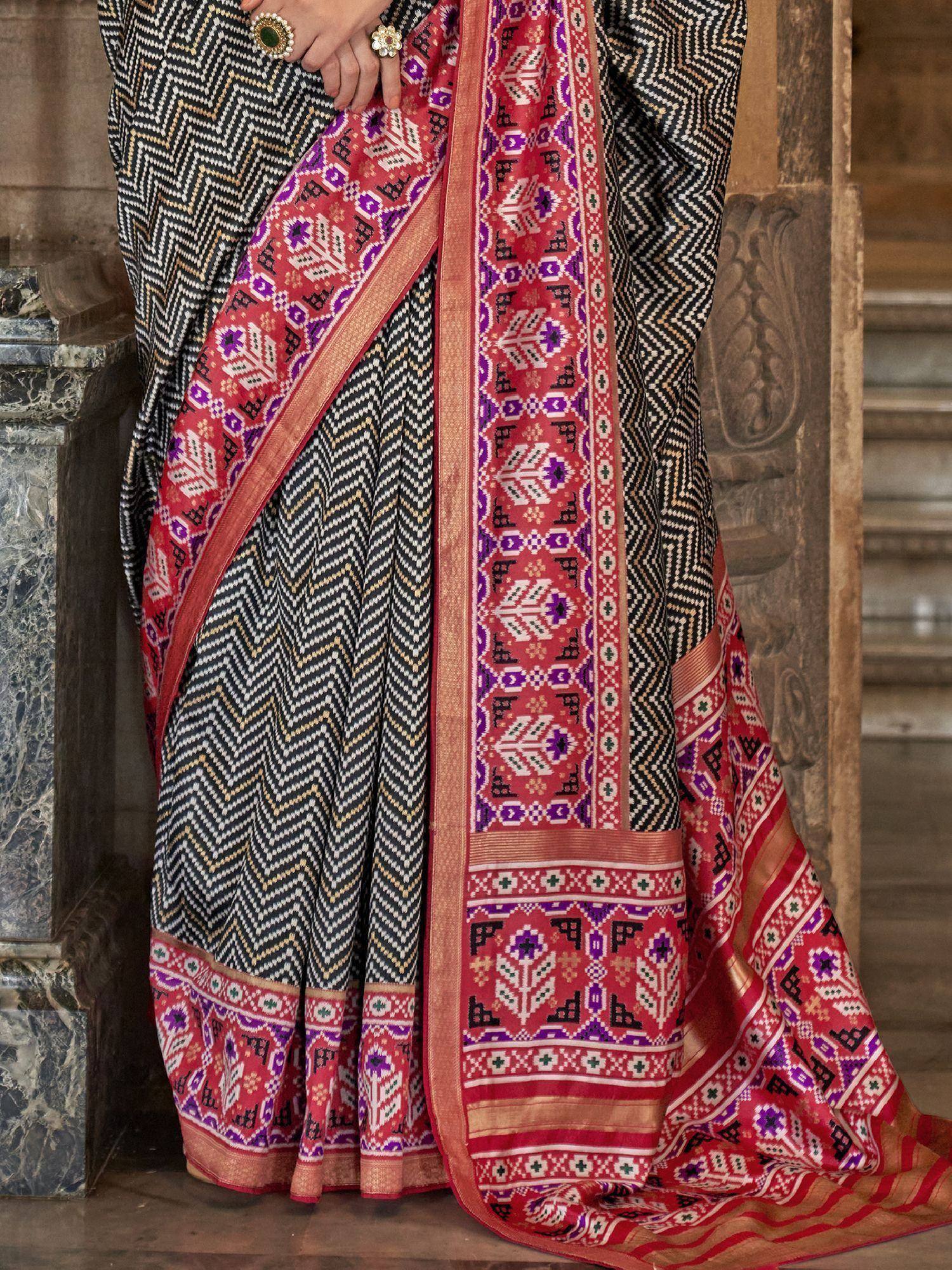 Black and red ethnic saree with geometric print and vibrant border, perfect for Indian occasions