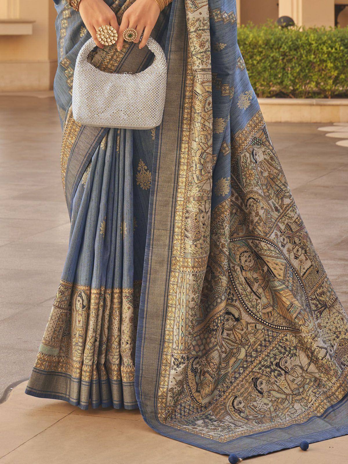 Blue designer saree with intricate gold temple motifs and pearl handbag, perfect for ethnic occasions