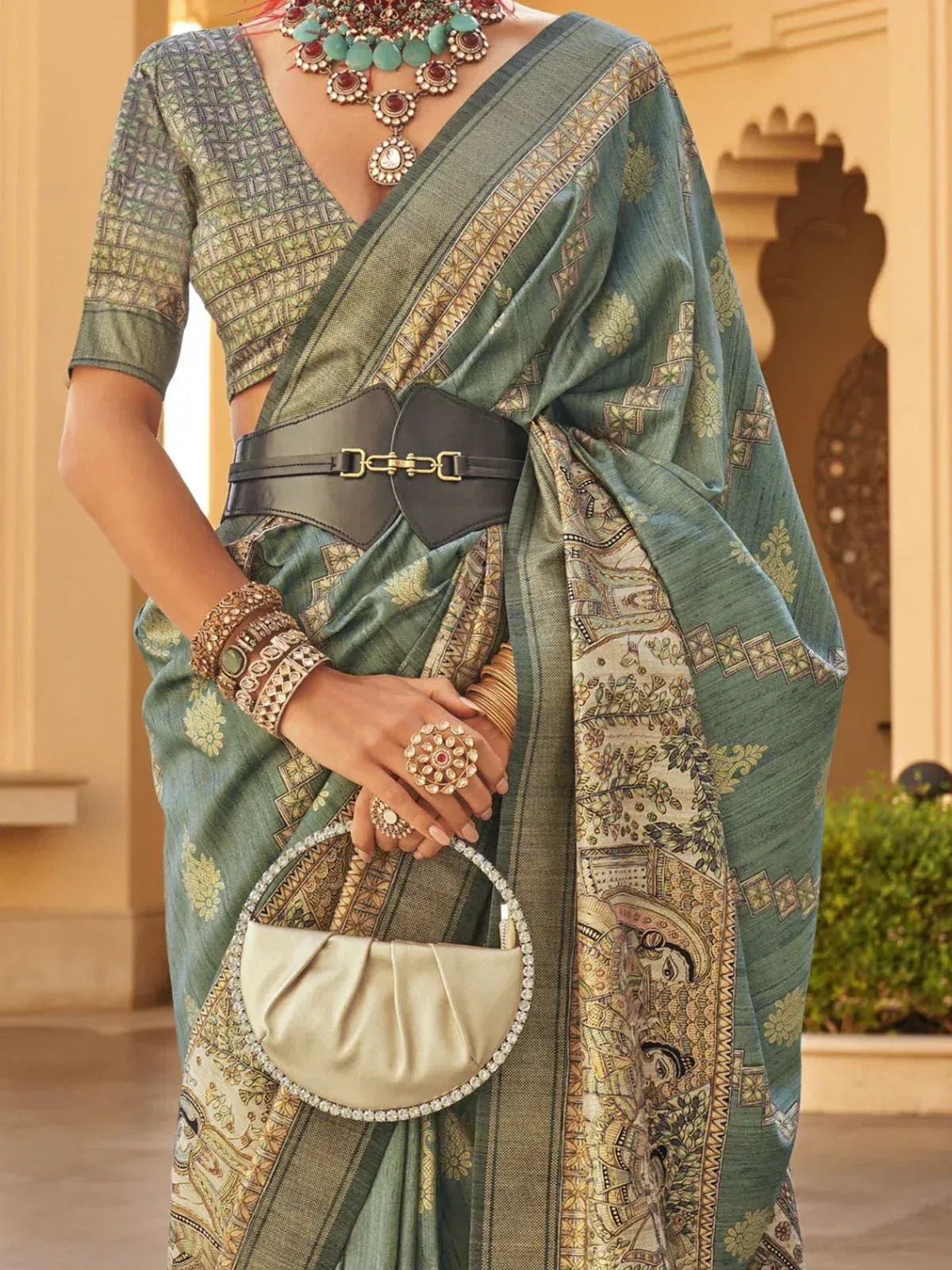 Green printed saree with designer blouse, statement jewelry, and belt - Indian ethnic wear