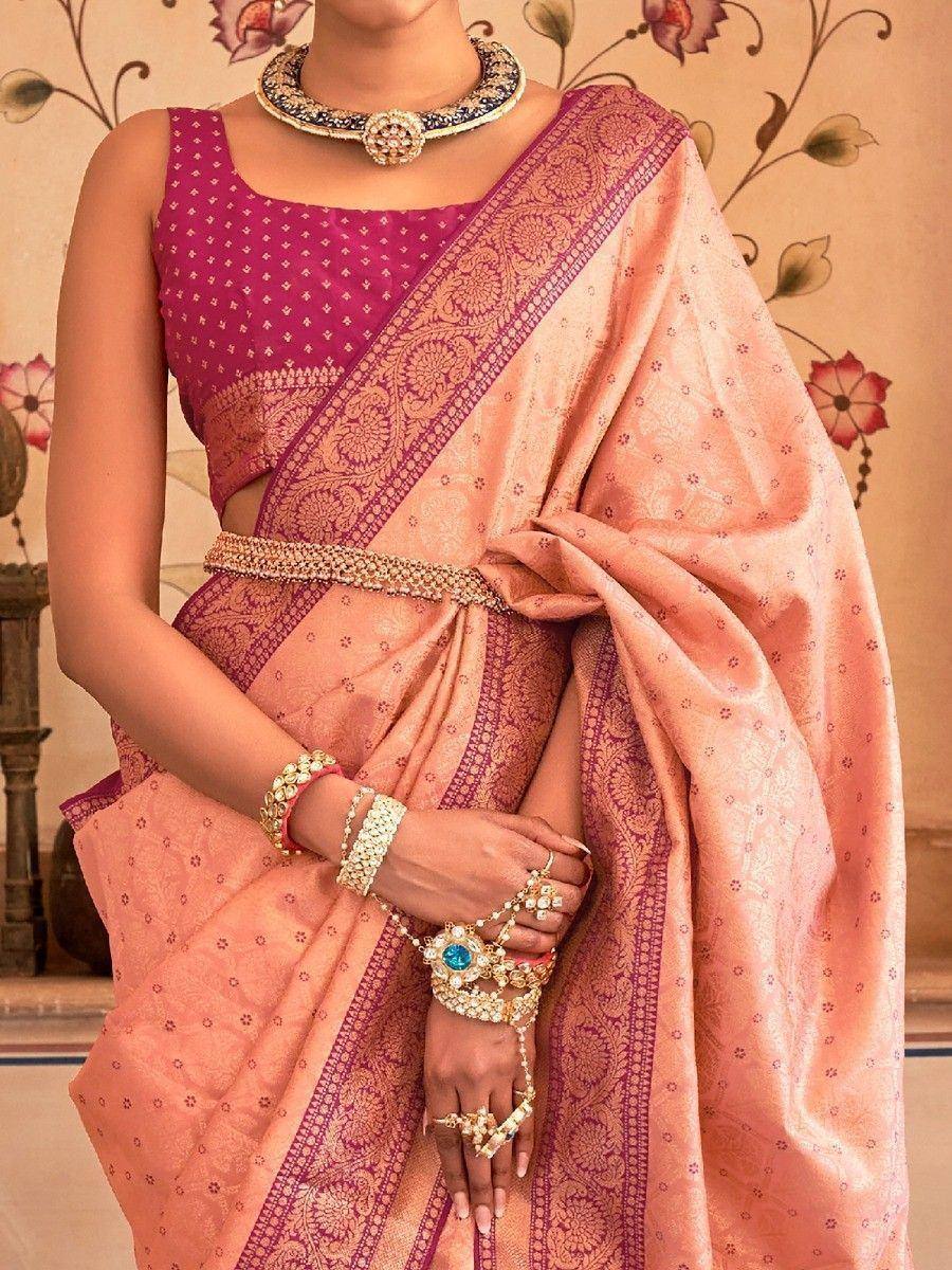 Pink and peach designer saree with gold embroidery, paired with traditional Indian jewelry for ethnic wear