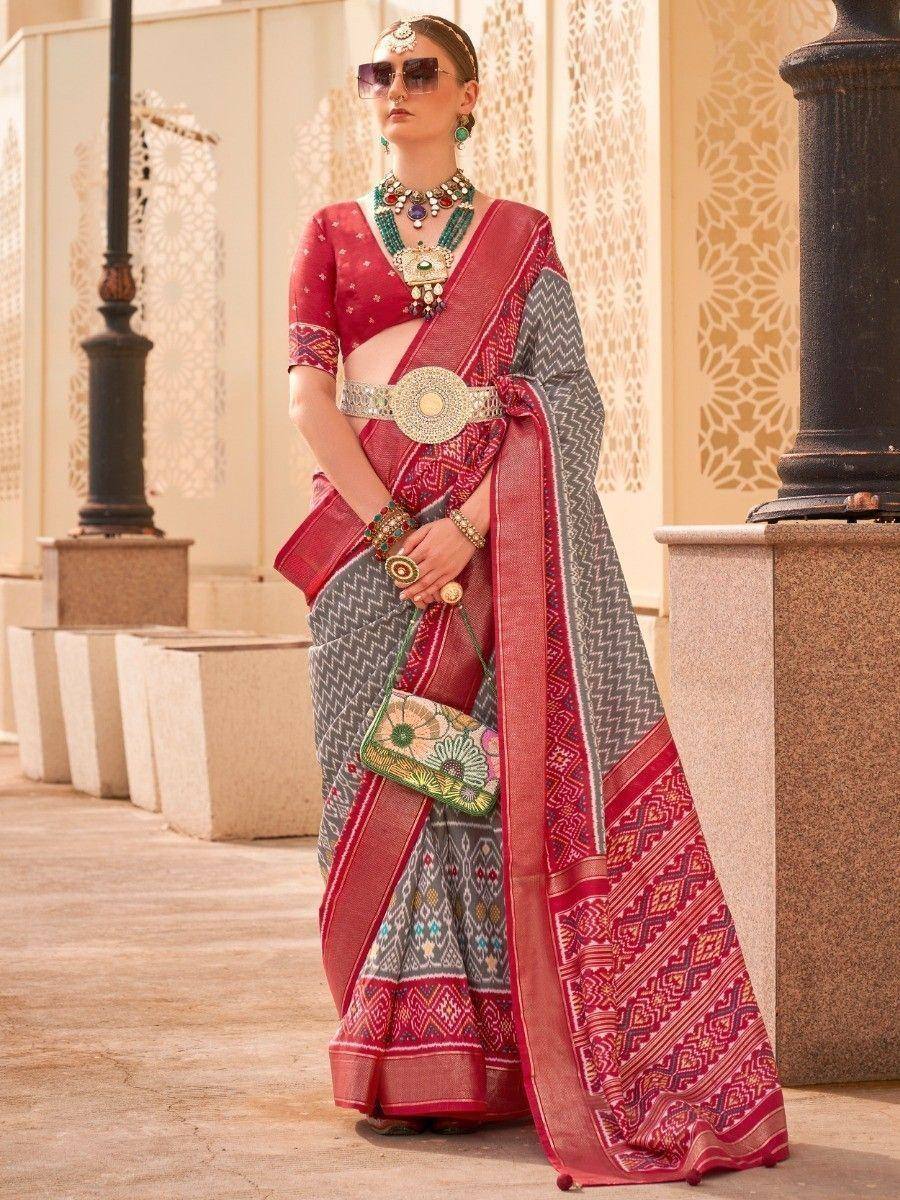 Red and gray printed saree with ethnic jewelry and designer blouse, perfect for Indian festive occasions