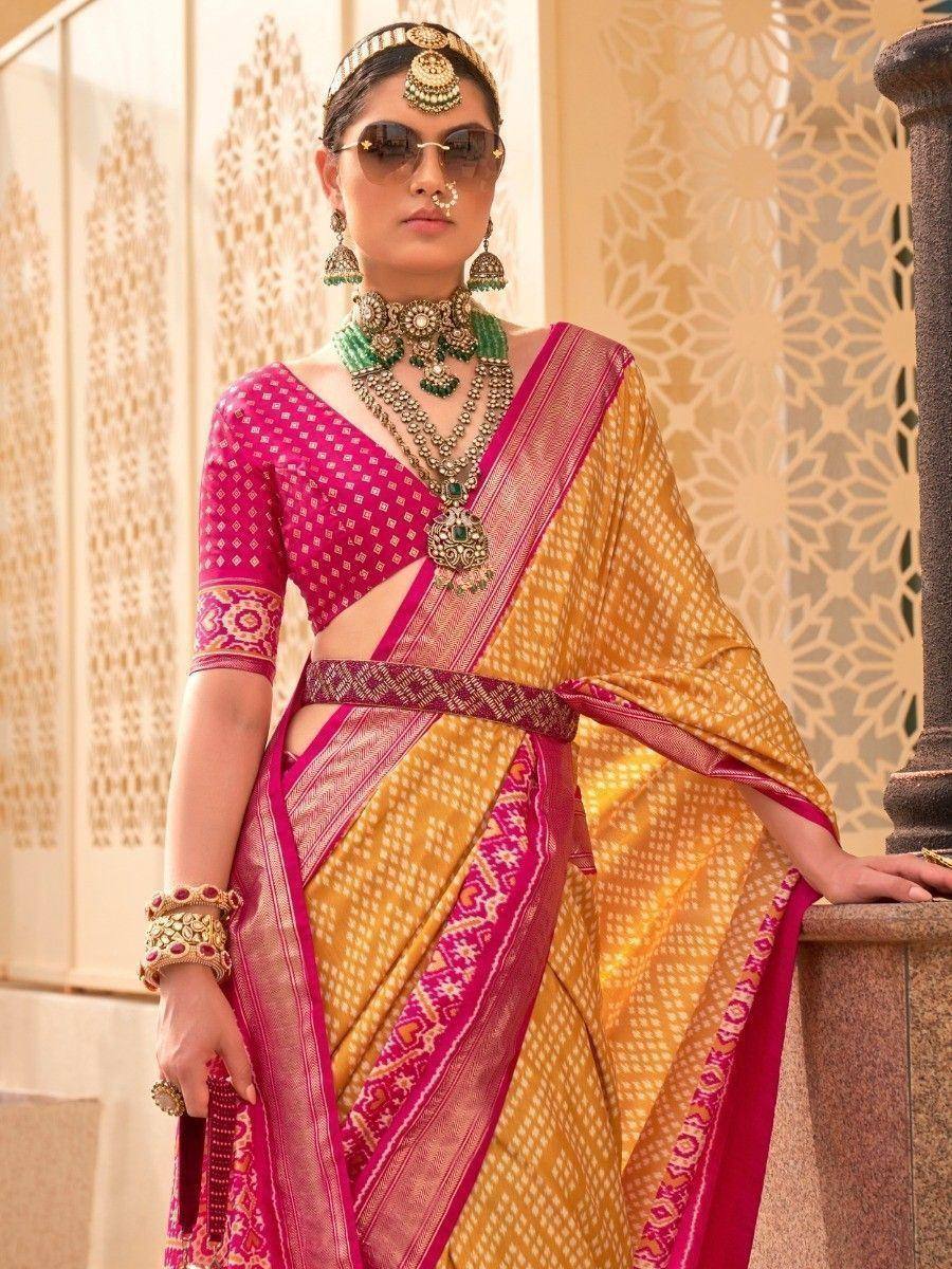 Elegant Indian saree with pink blouse, gold embroidery, and traditional jewelry for festive occasions