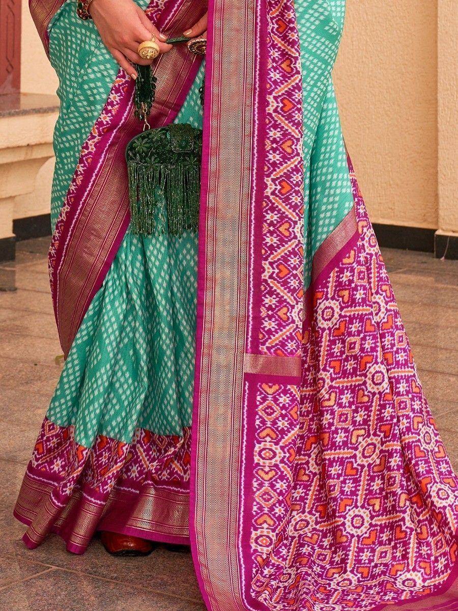 Teal and magenta ethnic saree with geometric border, perfect for Indian occasions