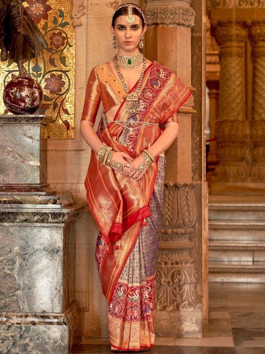 Elegant Indian woman in red and gold designer saree with heavy jewelry, traditional ethnic wear