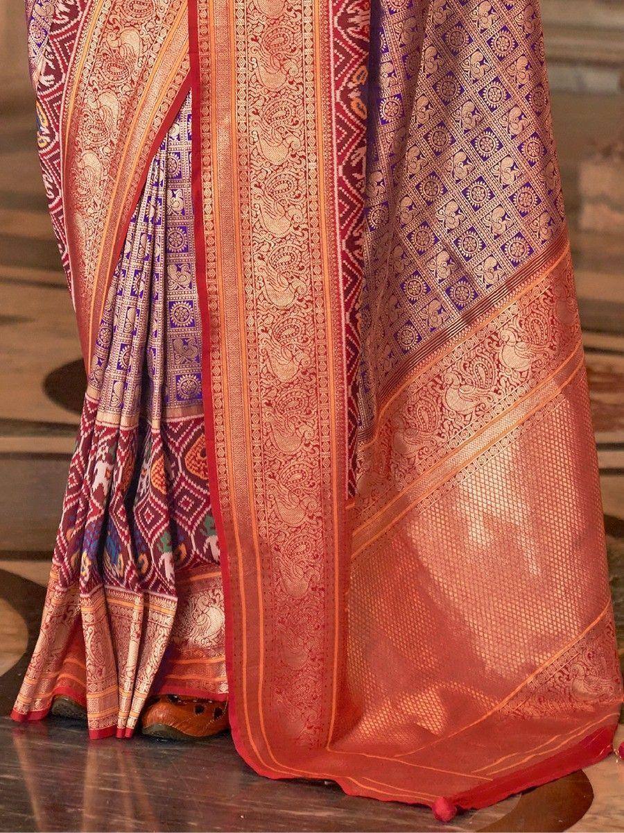 Richly embroidered orange and purple designer saree with intricate paisley and geometric patterns, perfect for ethnic occasions.