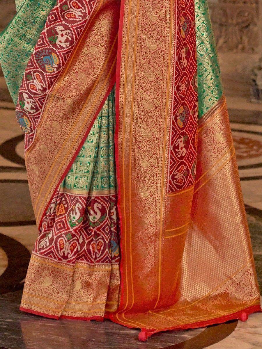 Designer silk saree with intricate red, green, and gold paisley and elephant motifs, perfect for Indian ethnic wear.