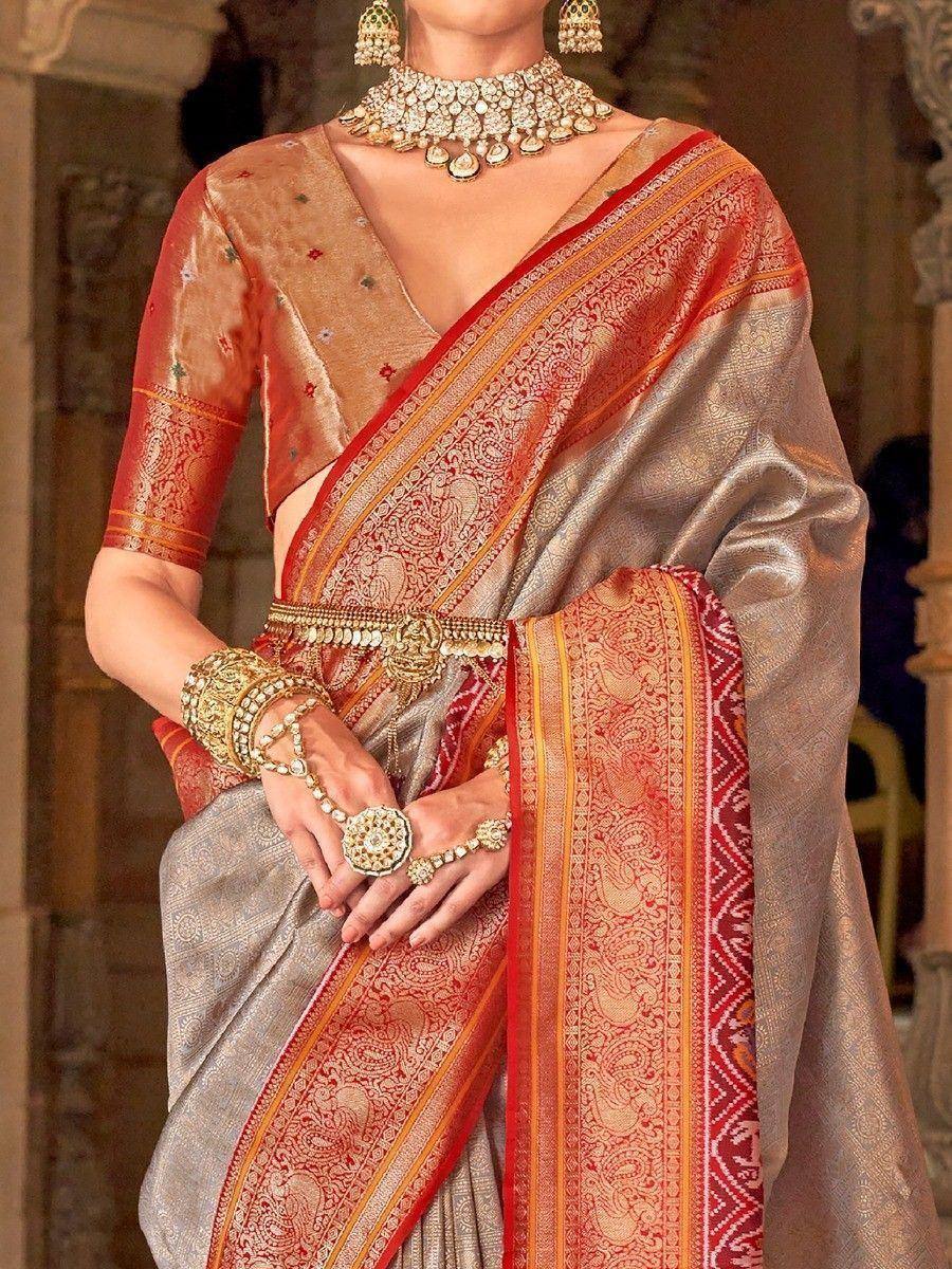 Elegant Indian saree with red and gold border, paired with traditional jewelry and blouse for ethnic wear