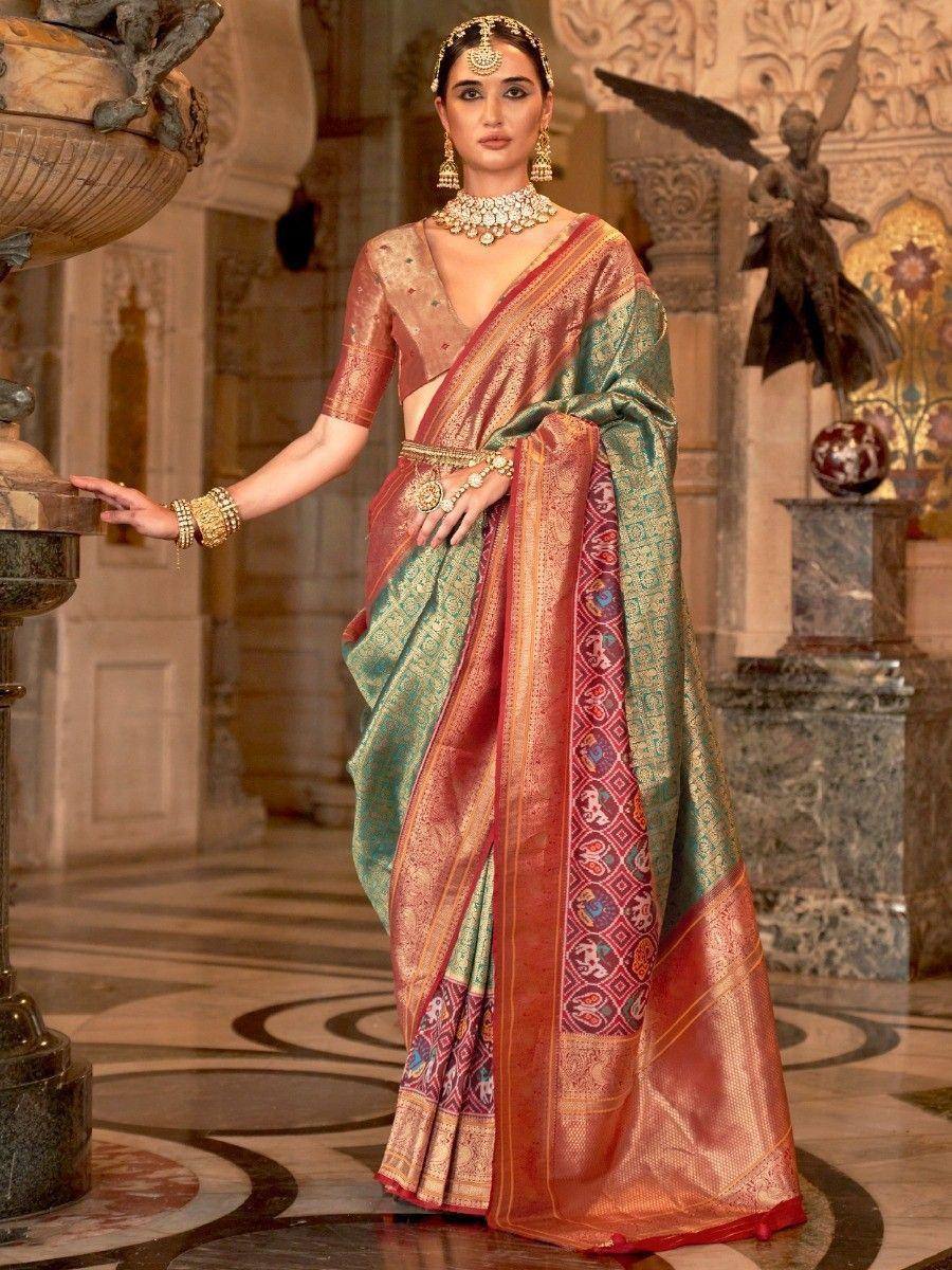 Elegant Indian saree with intricate patterns, paired with traditional jewelry and a richly decorated backdrop.