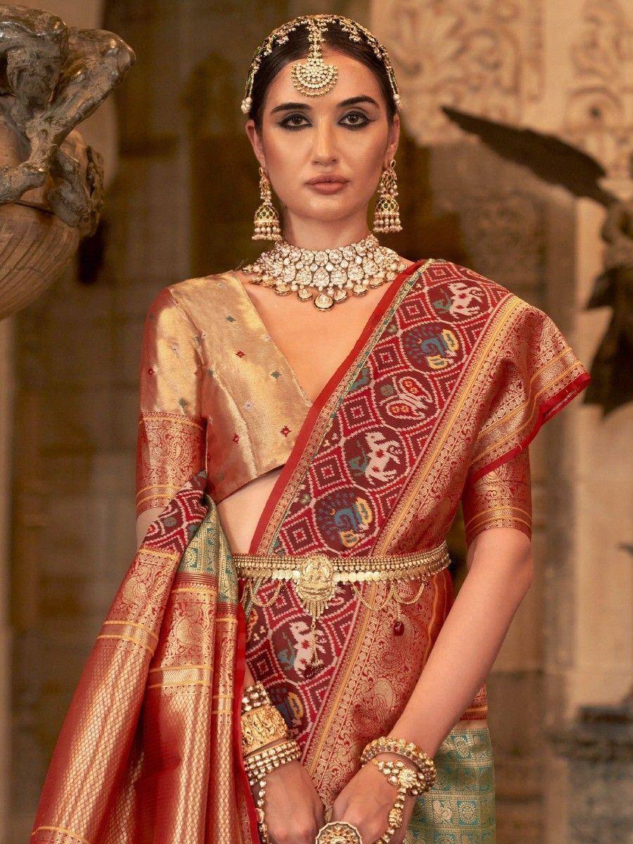 Elegant Indian saree with intricate patterns, gold jewelry, and traditional bridal accessories