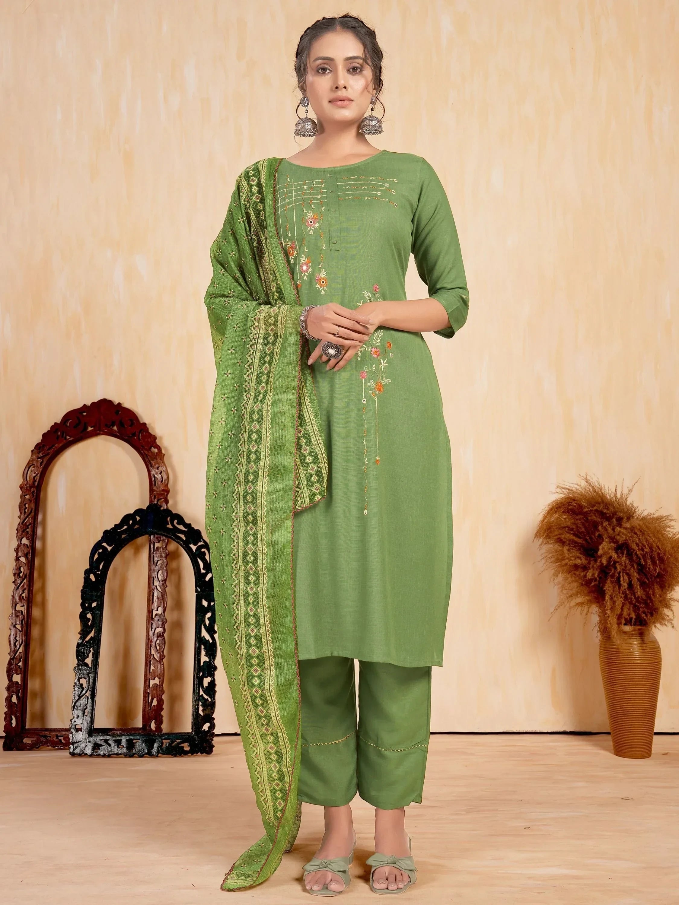 Woman wearing green embroidered salwar kameez with matching dupatta, ethnic wear outfit