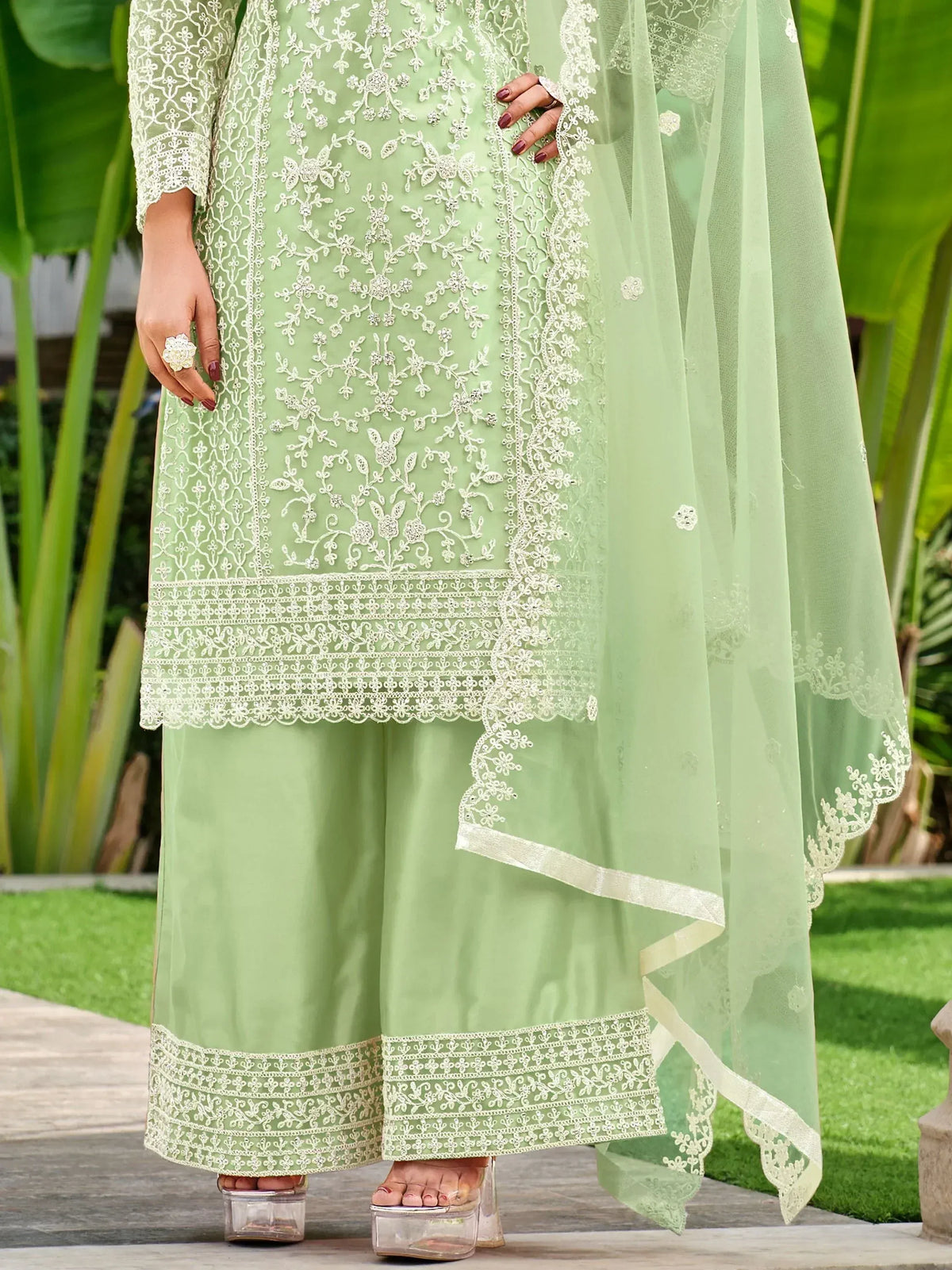 Mint green embroidered salwar kameez with lace detailing and matching dupatta, perfect for ethnic occasions.