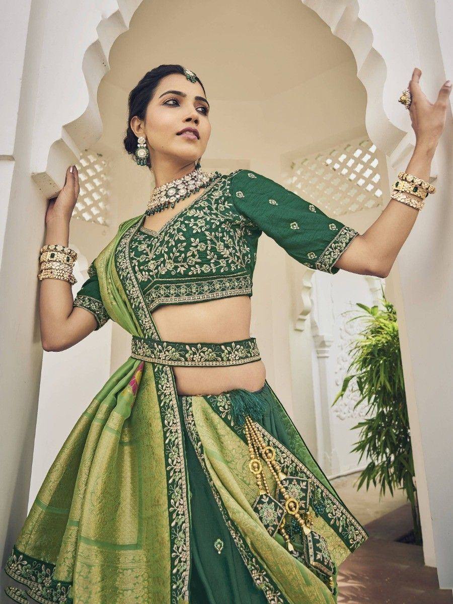 Emerald green embroidered lehenga choli with gold detailing, perfect for Indian weddings and festive occasions