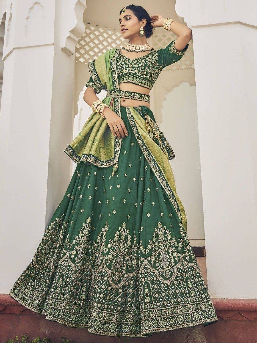 Emerald green designer lehenga choli with gold embroidery, perfect for Indian weddings and festive occasions.