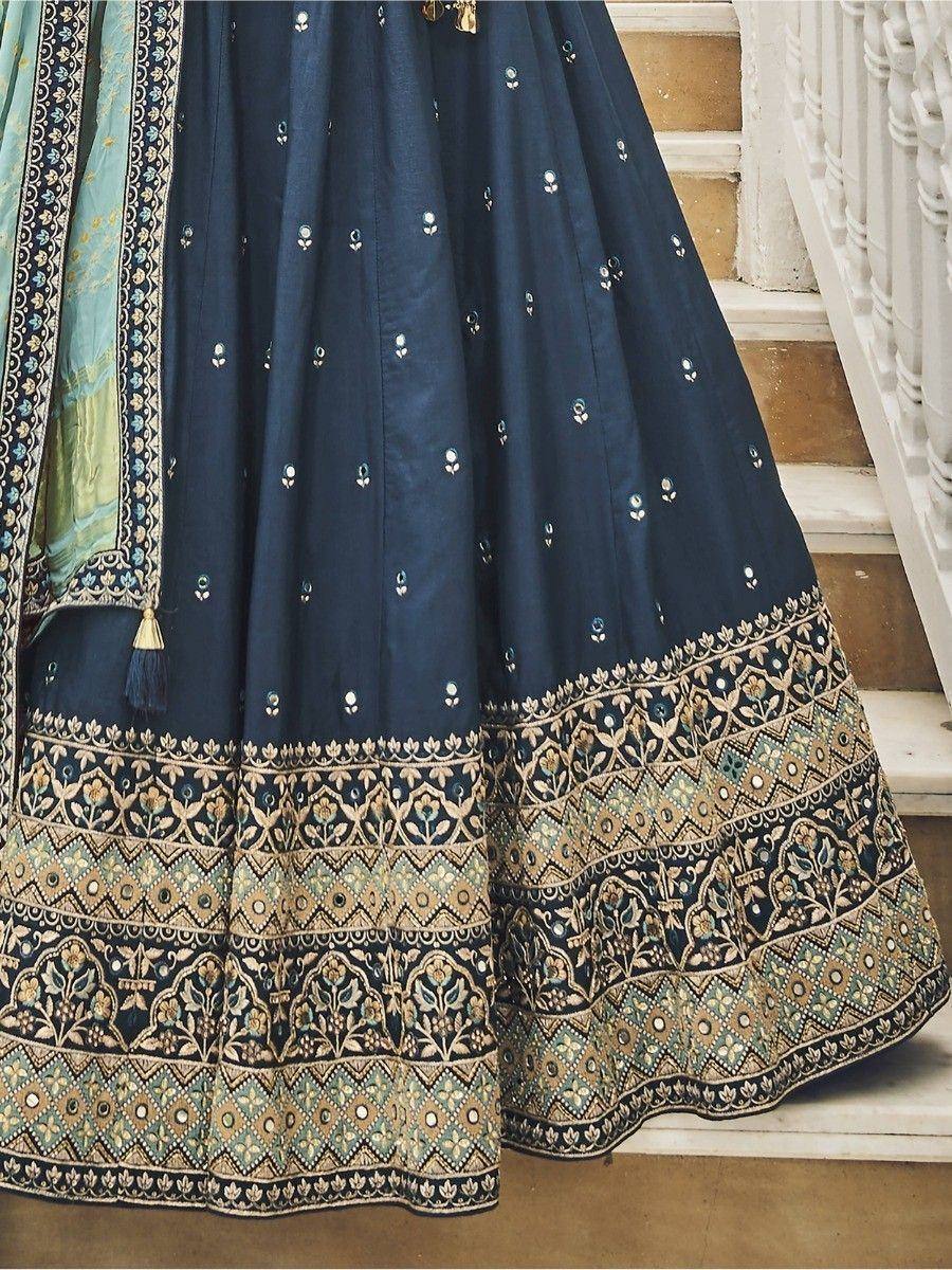 Navy blue designer lehenga with gold and teal embroidery, perfect for Indian ethnic wear occasions.
