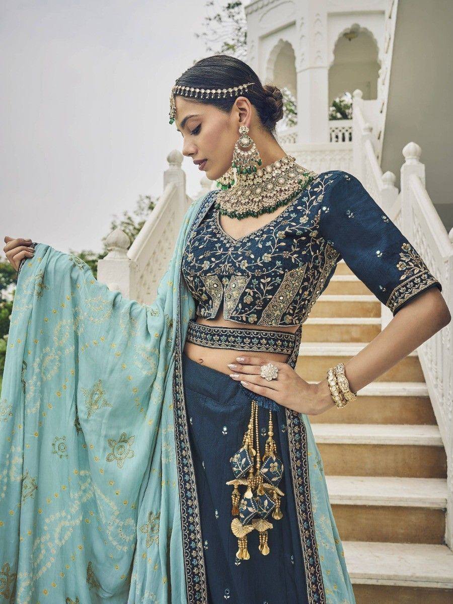 Elegant navy blue embroidered lehenga choli with mint dupatta, perfect for Indian ethnic occasions.