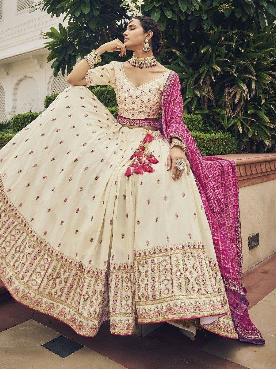 Elegant cream and pink embroidered lehenga choli with matching dupatta, perfect for Indian weddings and festive occasions.