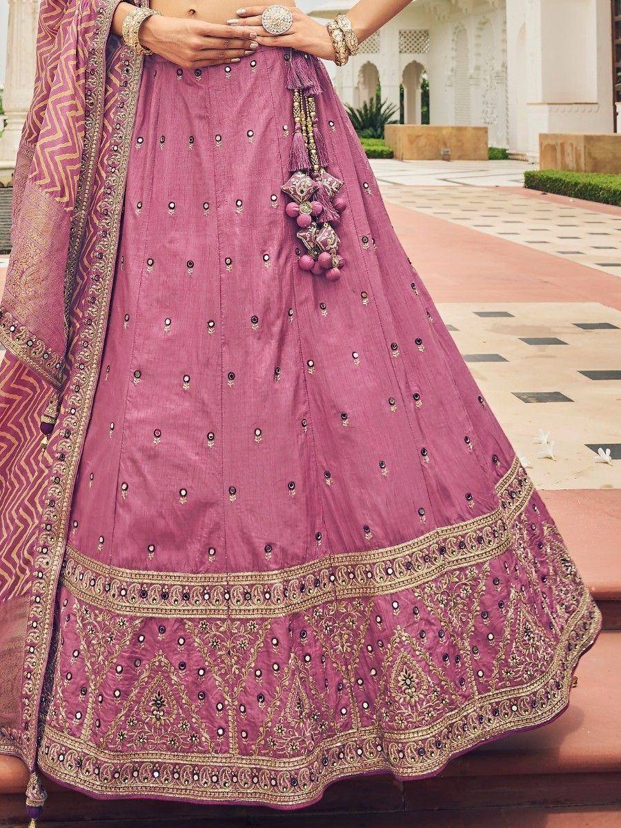 Pink designer lehenga choli with gold embroidery and tassels, perfect for Indian ethnic wear occasions