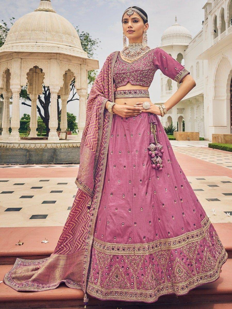 Elegant mauve lehenga choli with gold embroidery, perfect for Indian weddings and festive occasions.