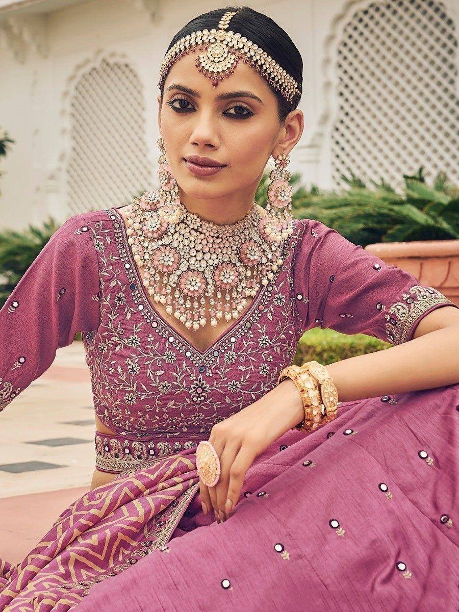 Elegant purple lehenga choli with floral embroidery, statement jewelry, and traditional Indian bridal accessories.