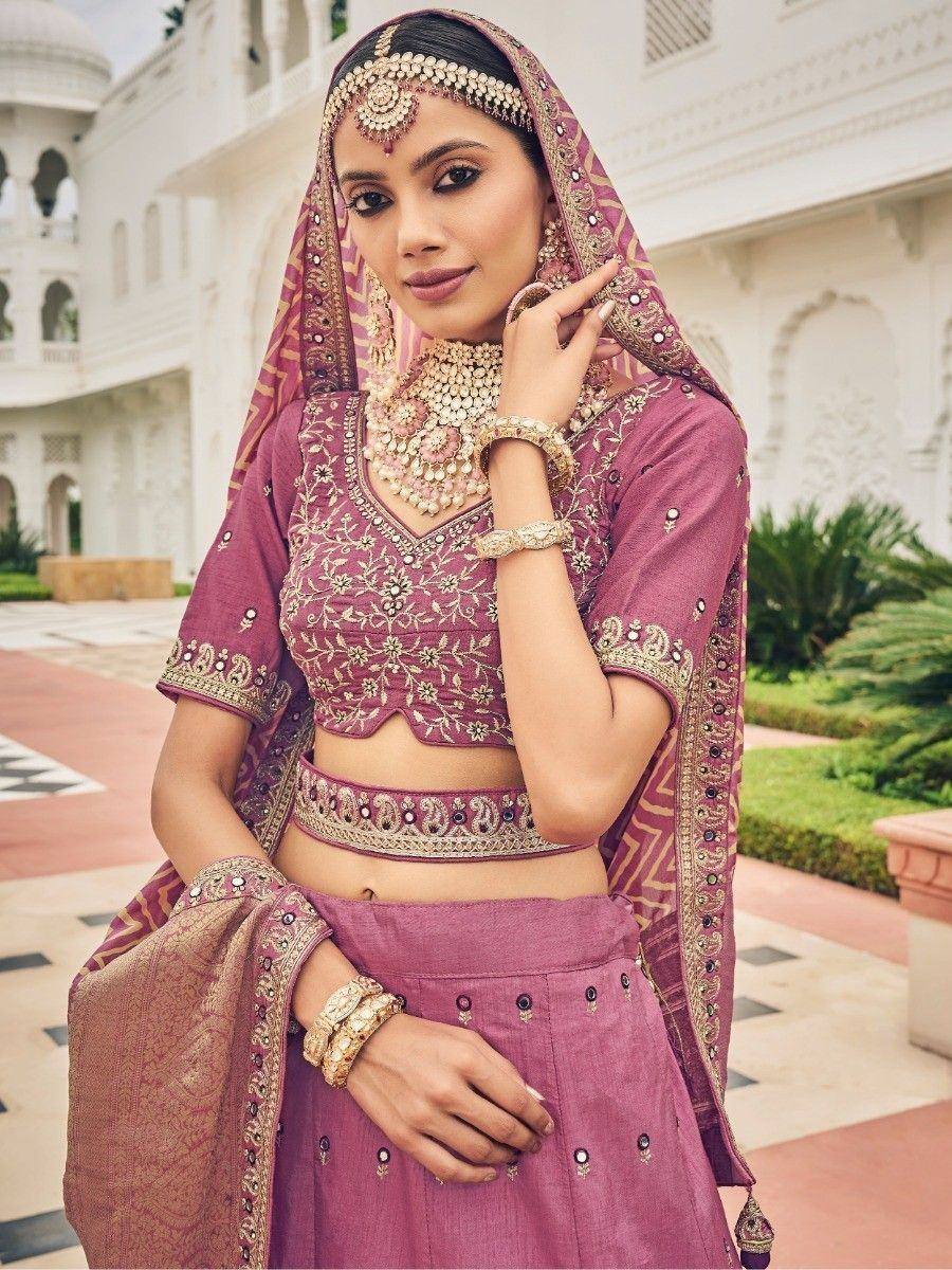 Elegant mauve lehenga choli with gold embroidery, perfect for Indian weddings and festive occasions.