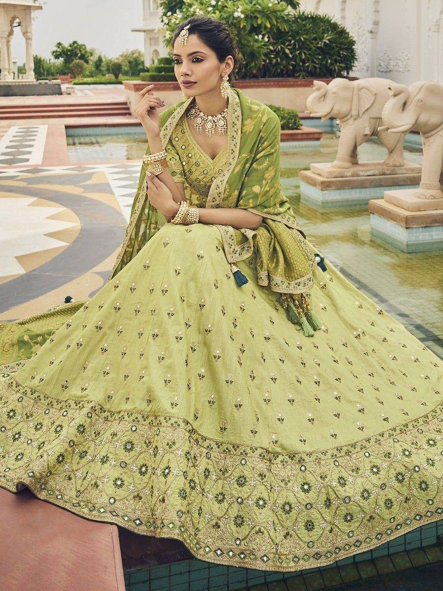 Elegant green designer lehenga choli with intricate embroidery, perfect for Indian ethnic wear occasions.