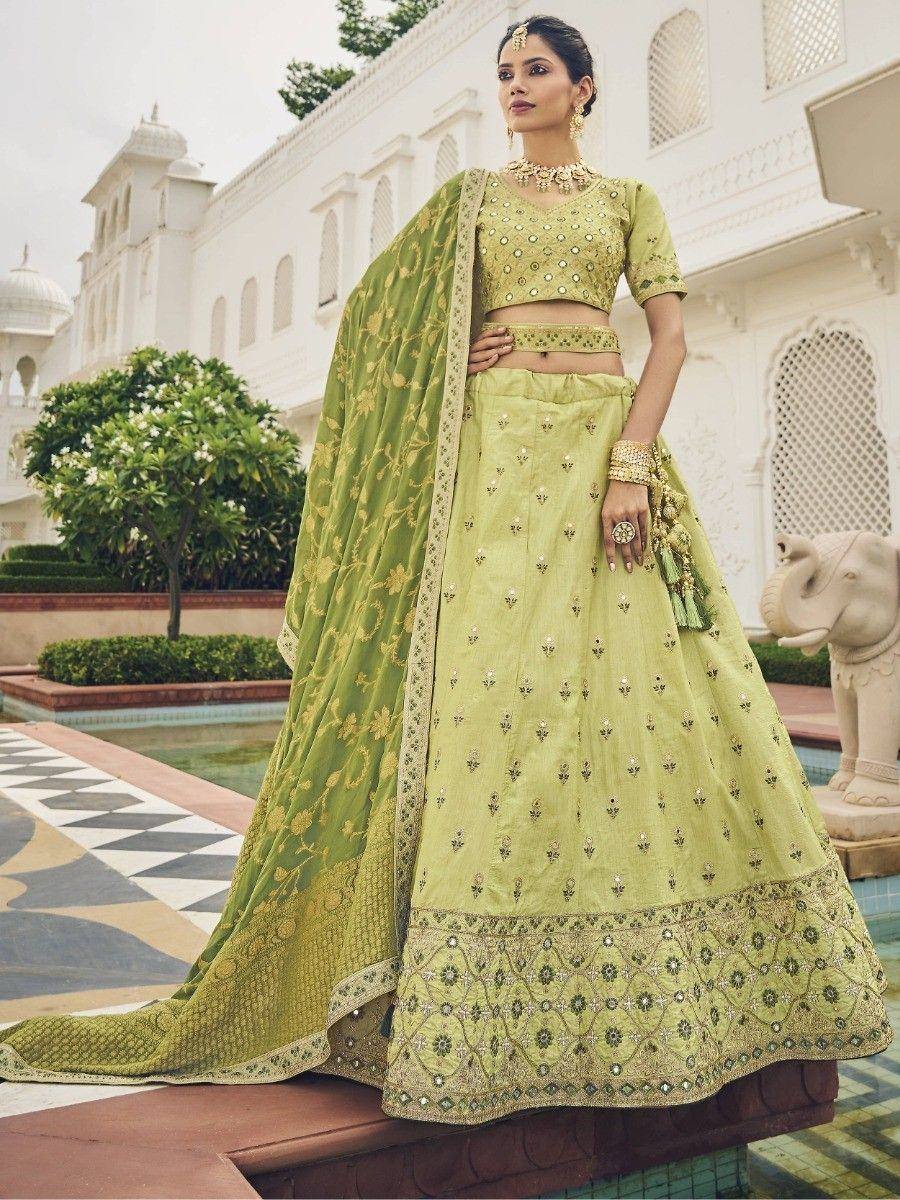 Light green embroidered lehenga choli with gold detailing, perfect for Indian weddings and festive occasions