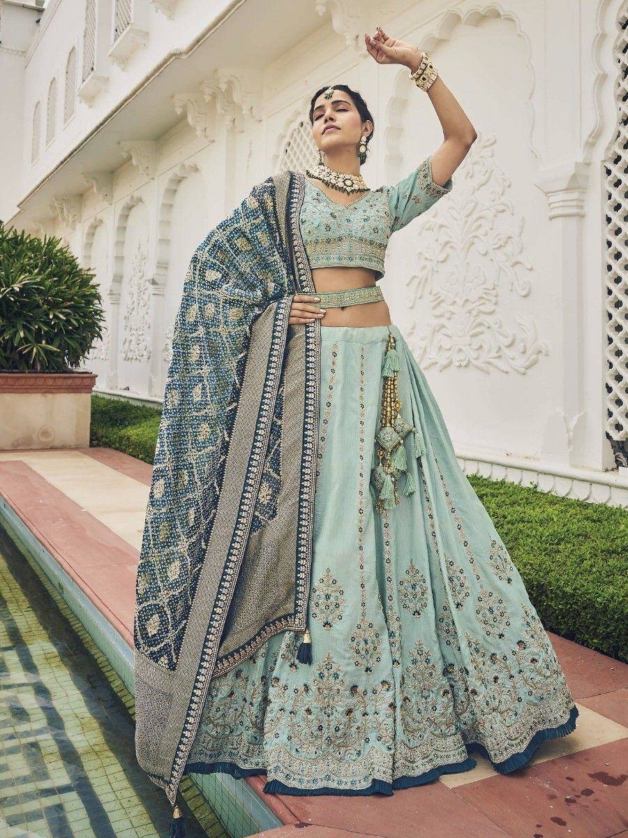 Mint green designer lehenga choli with intricate embroidery and matching dupatta, perfect for Indian weddings