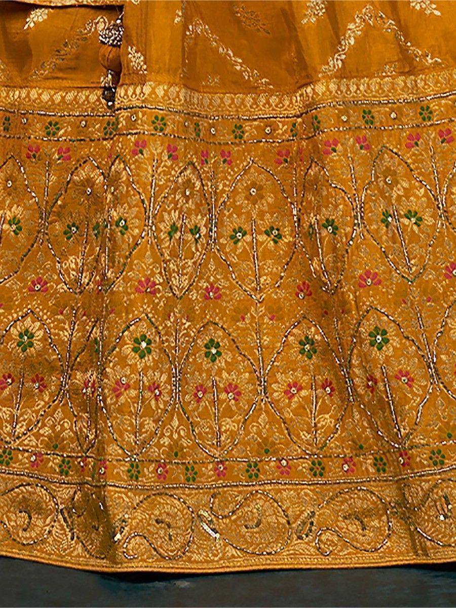 Mustard yellow lehenga with intricate floral embroidery and mirror work, perfect for Indian ethnic wear.