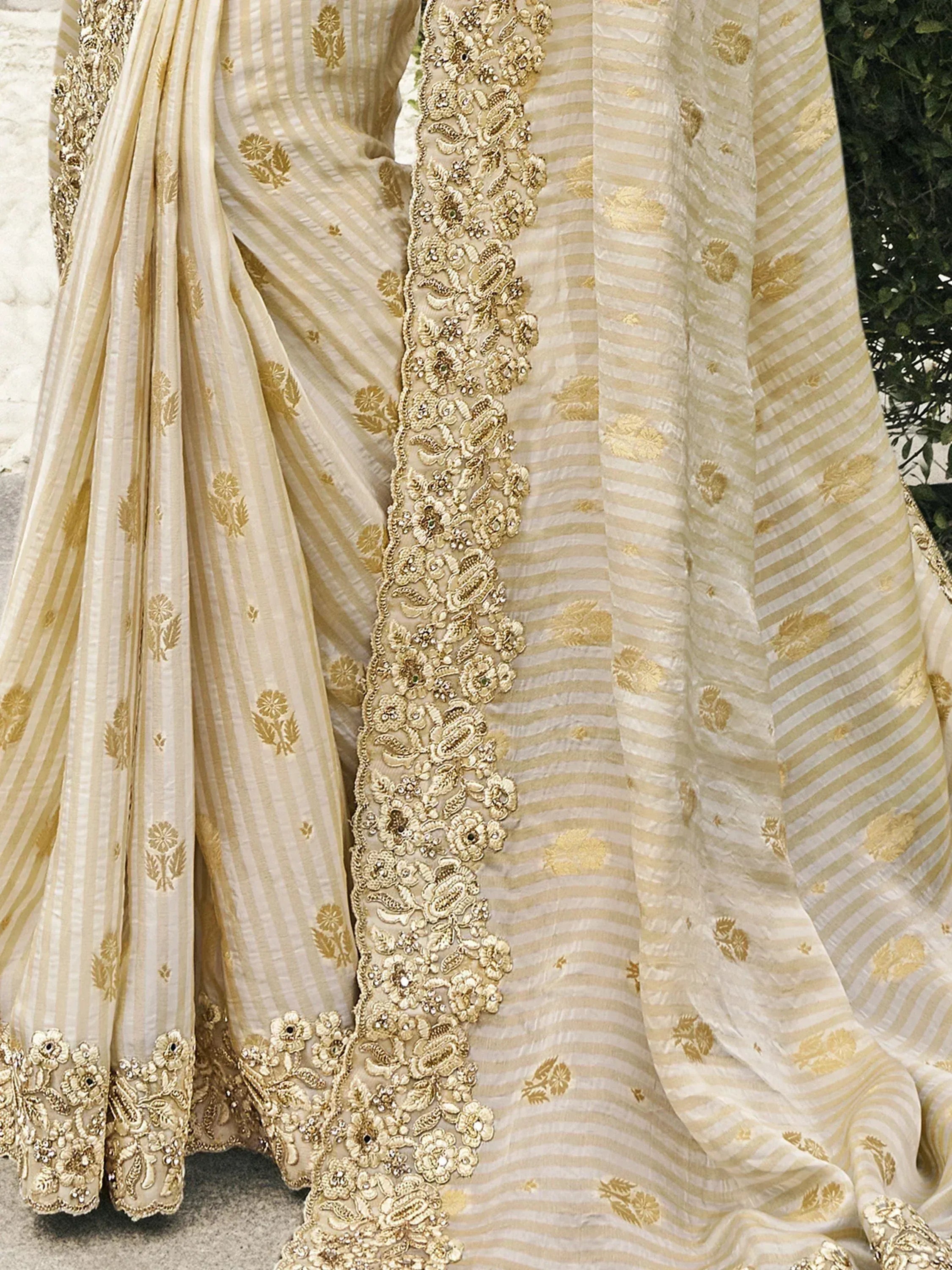 Elegant beige and gold striped lehenga with intricate floral embroidery and embellished border