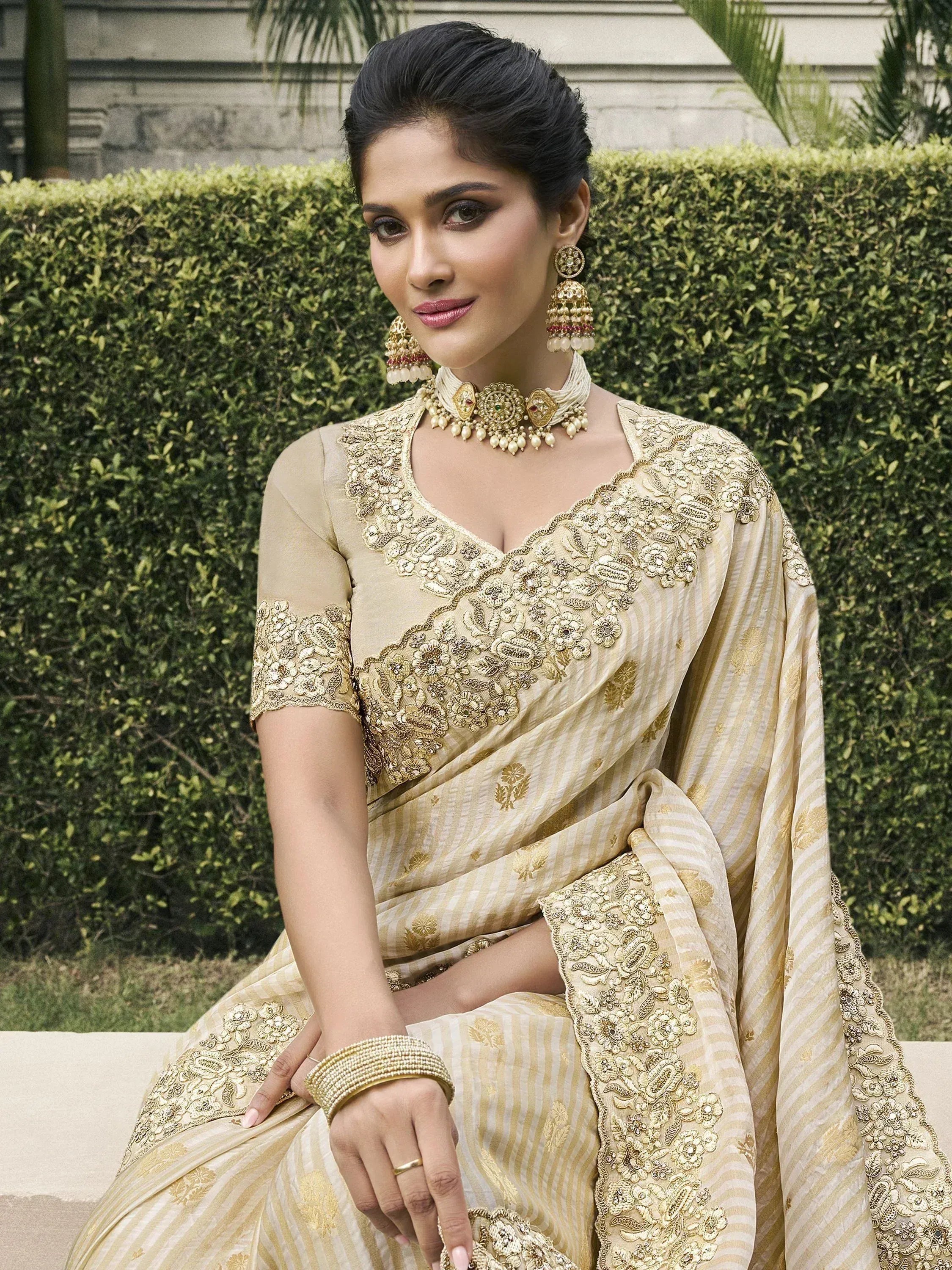 Elegant beige saree with gold embroidery, perfect for Indian ethnic wear and festive occasions.
