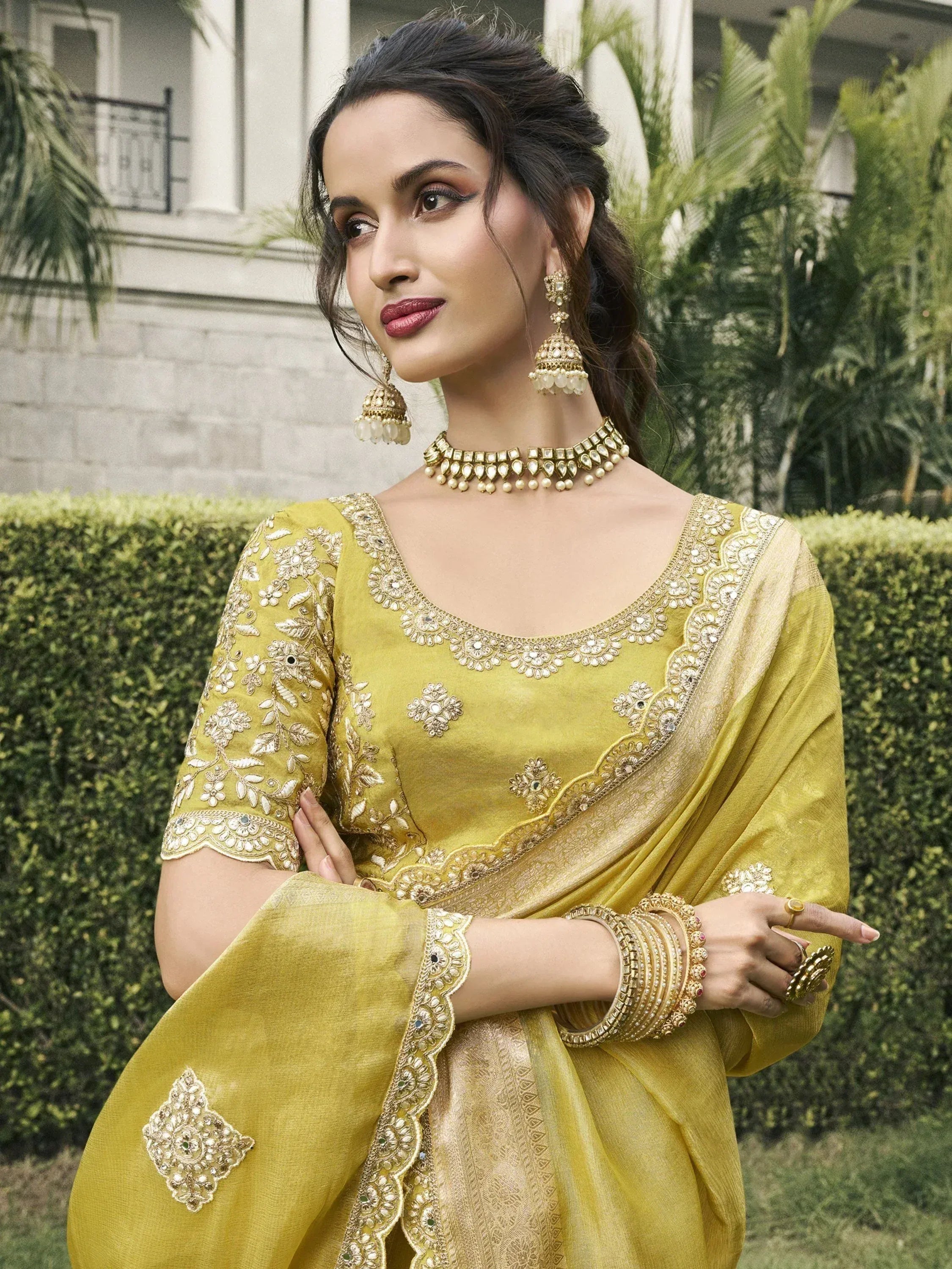 Yellow embroidered designer salwar kameez with gold jewelry, perfect for Indian ethnic wear occasions