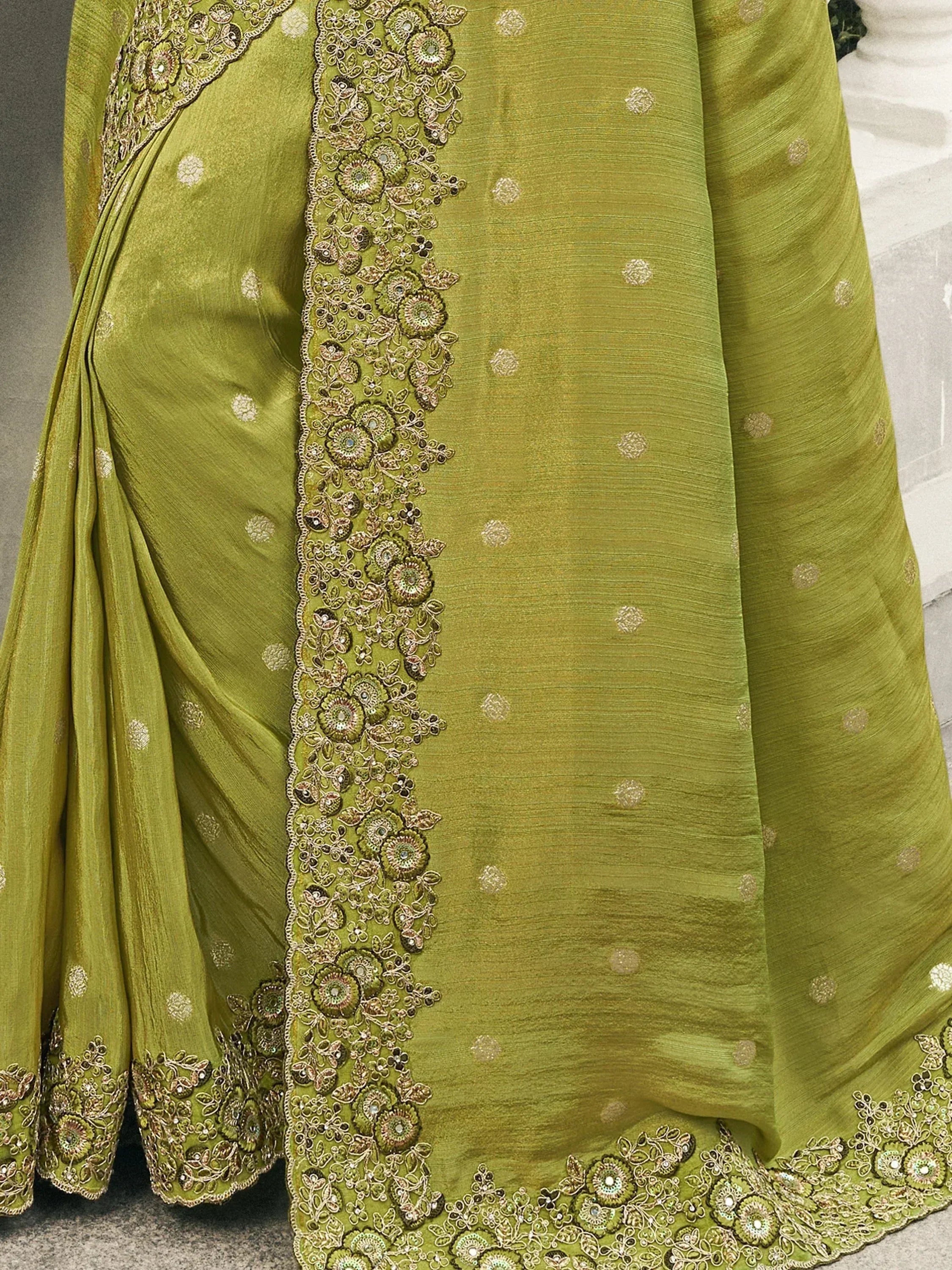 Olive green designer saree with intricate floral embroidery and sequin work, perfect for ethnic occasions.