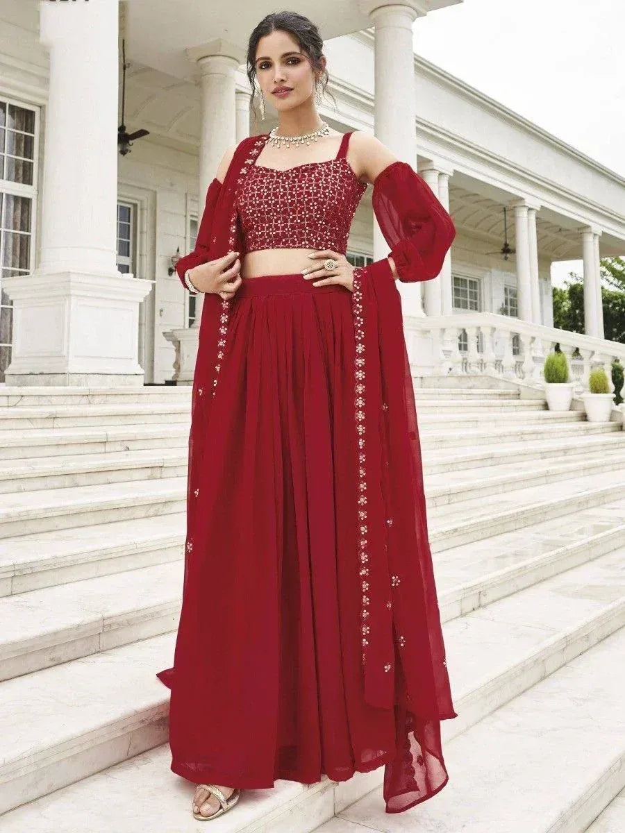 Red embroidered lehenga choli with off-shoulder top and sheer dupatta, perfect for Indian ethnic occasions