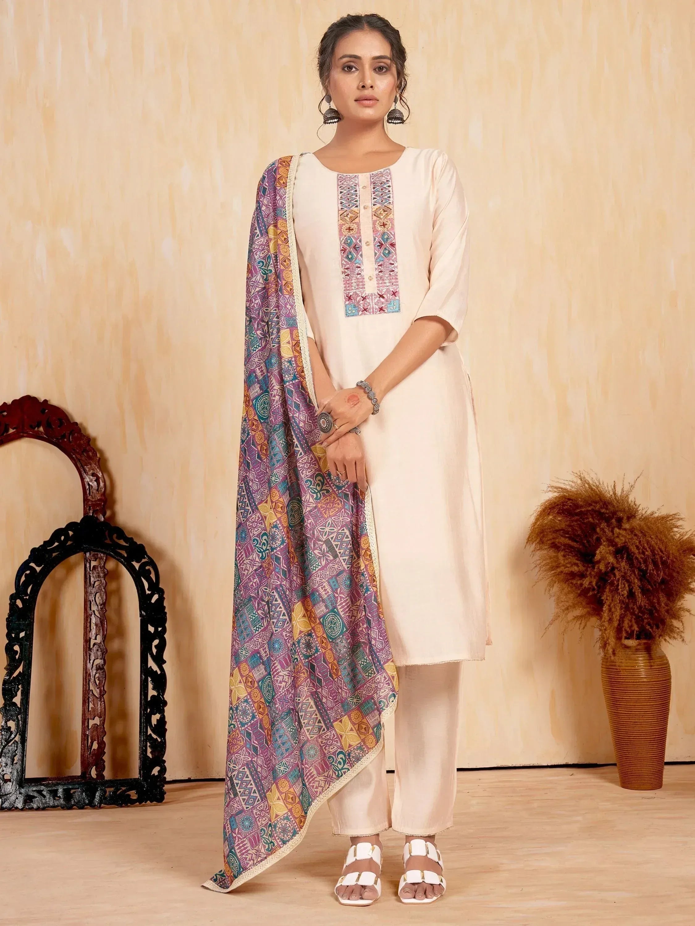 Elegant cream salwar kameez with colorful embroidered dupatta, perfect for Indian ethnic wear