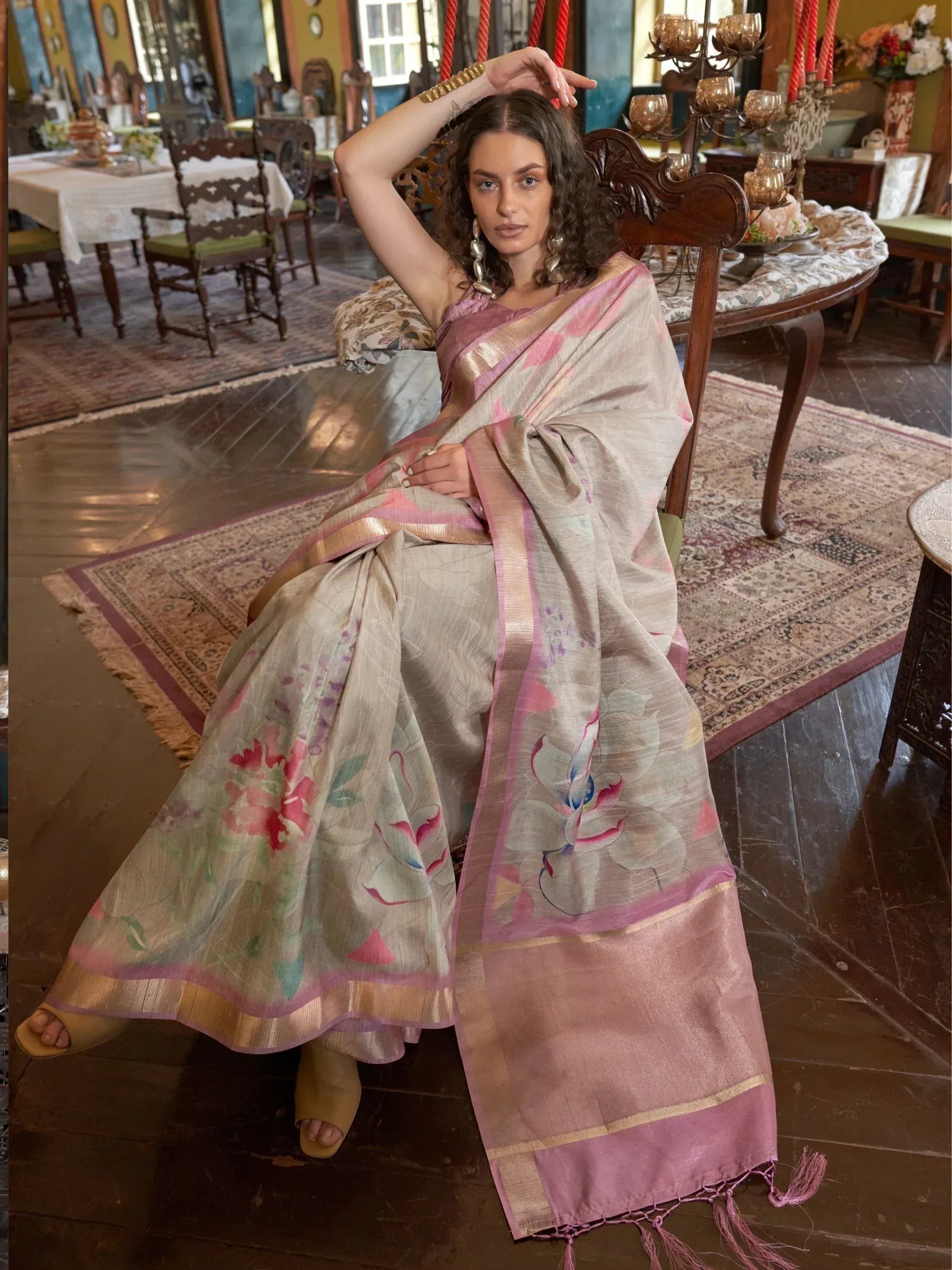 Woman in elegant floral print saree with pink border, traditional Indian ethnic wear