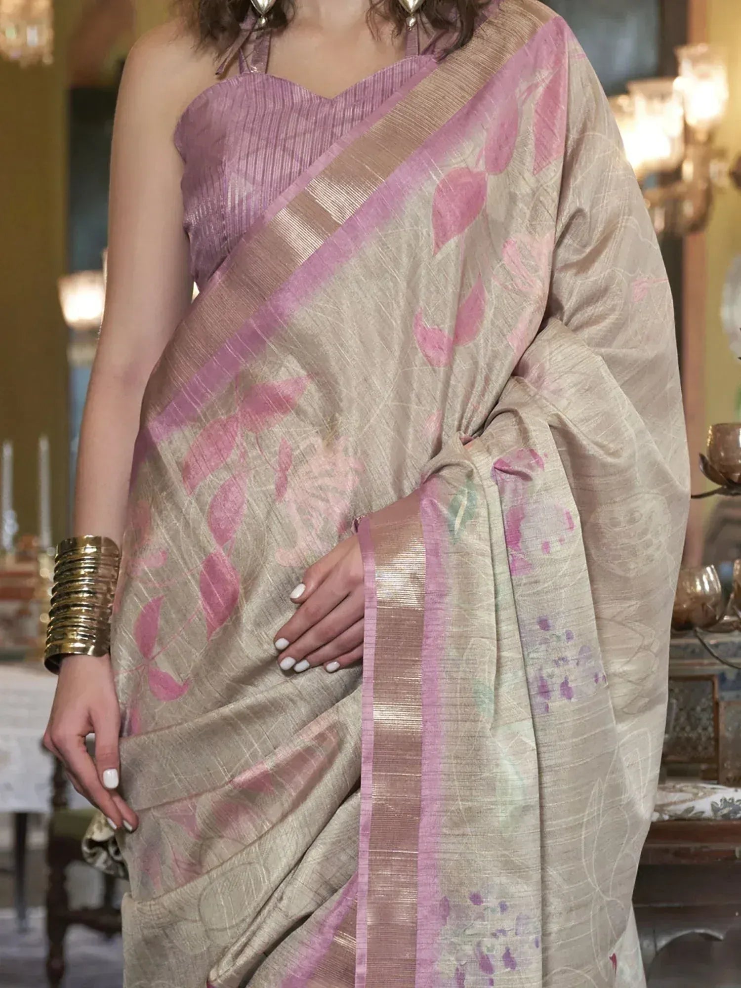 Beige saree with pink floral print and purple border, paired with matching blouse for ethnic wear