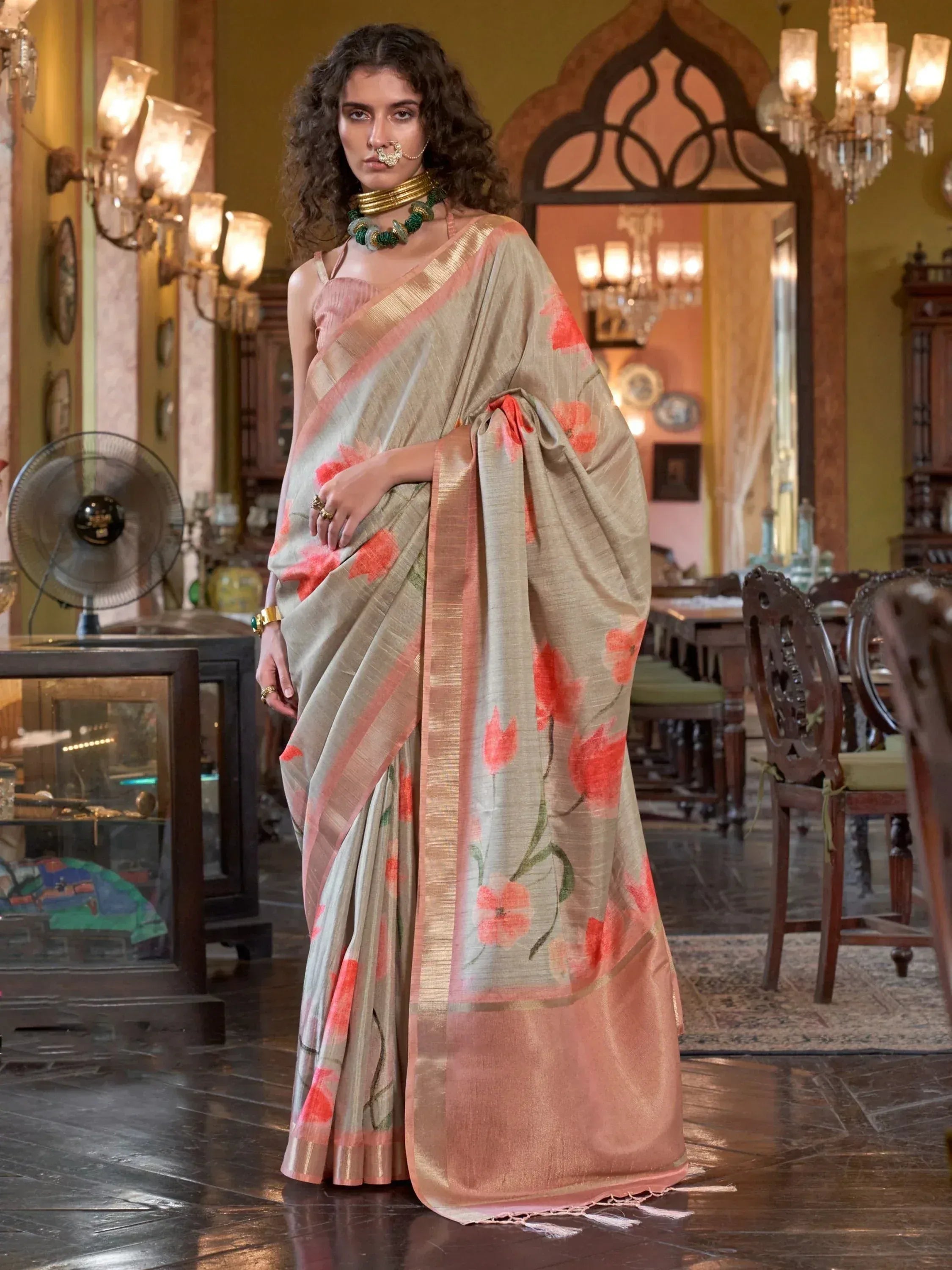 Woman in elegant floral saree with gold border, traditional Indian ethnic wear for festive occasions